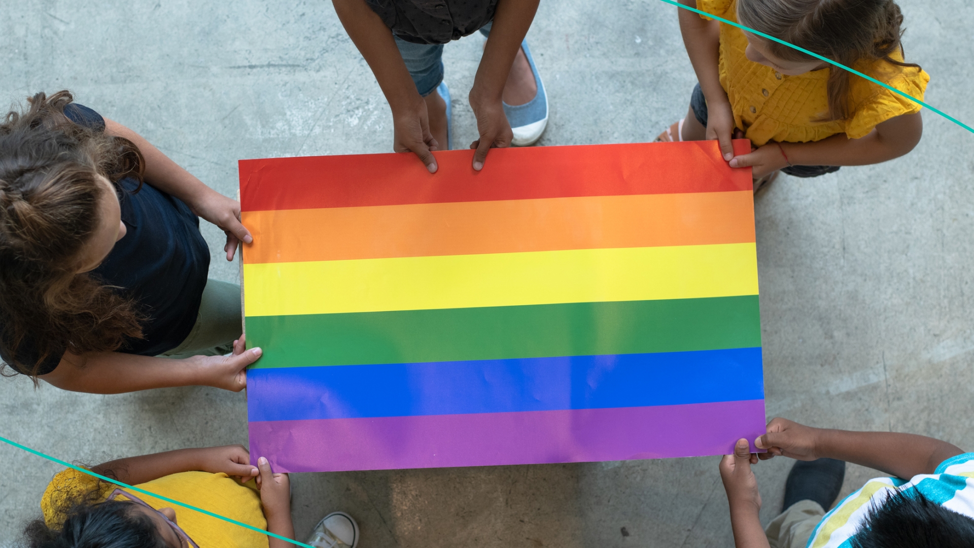 Woman and young daughter at LGBTQ+ rally with rainbow flag.