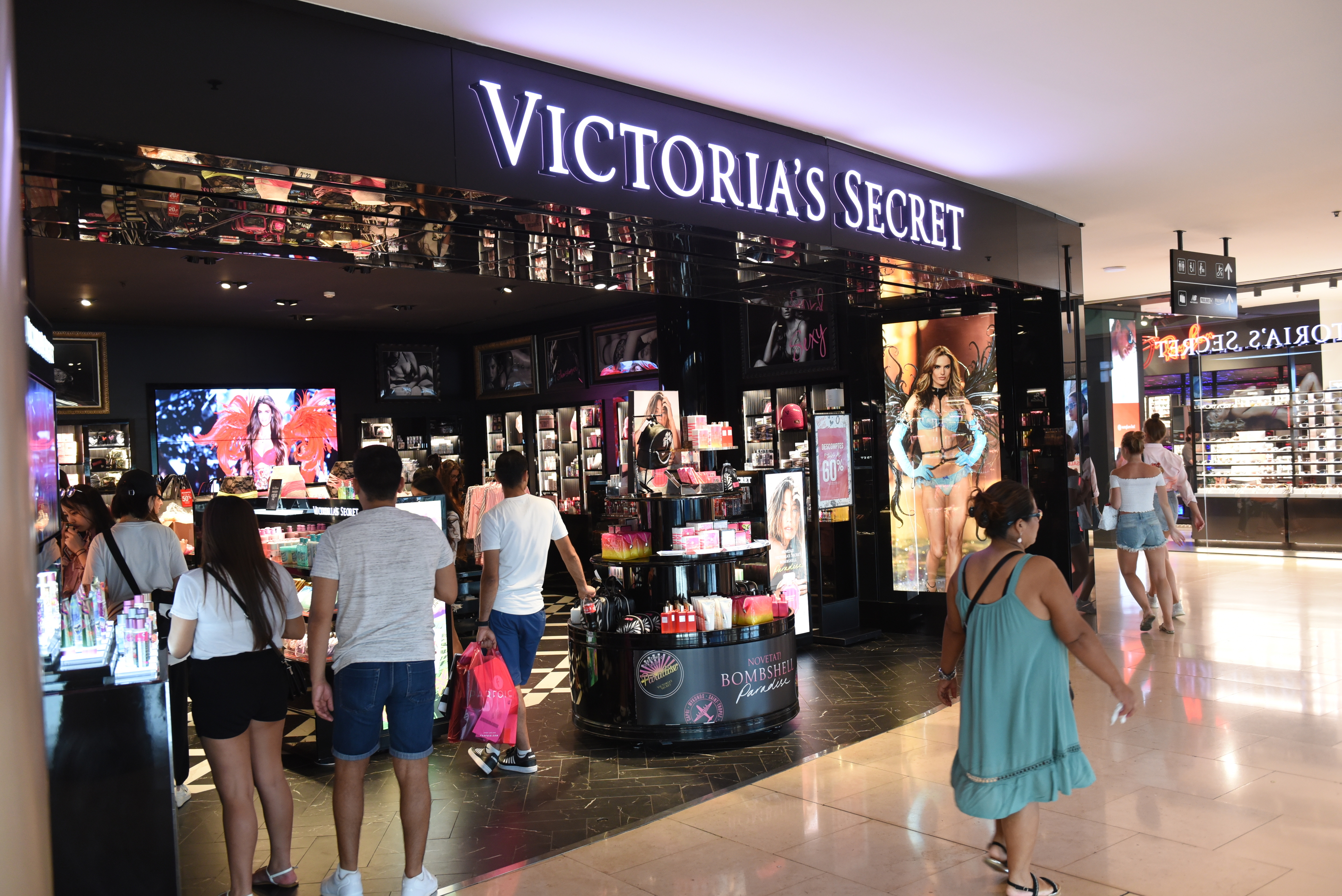A Victoria's Secret in a mall with people walking in and out
