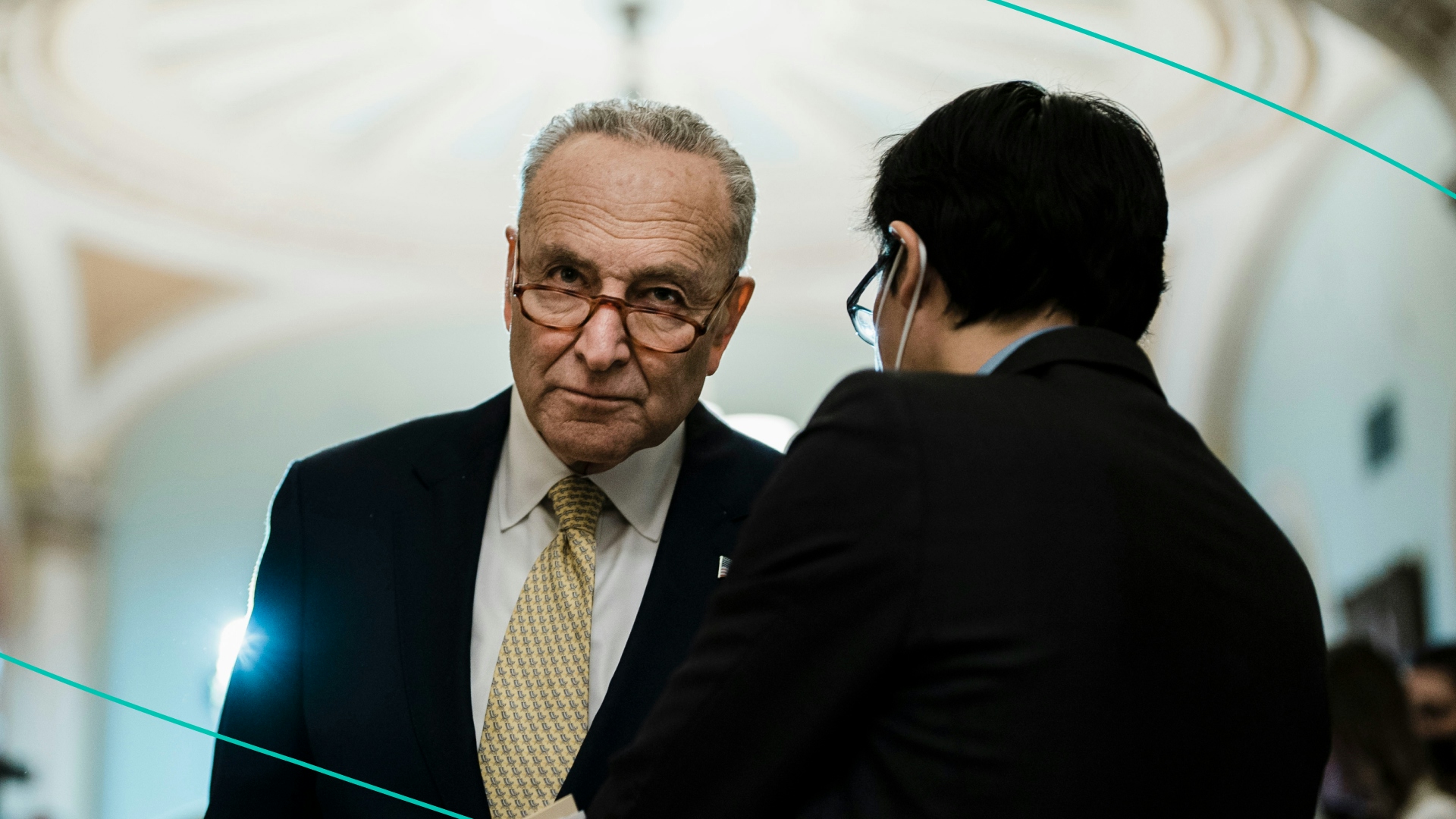 Senate Majority Leader Chuck Schumer (D-NY) speaks with an aide in Washington, DC. 