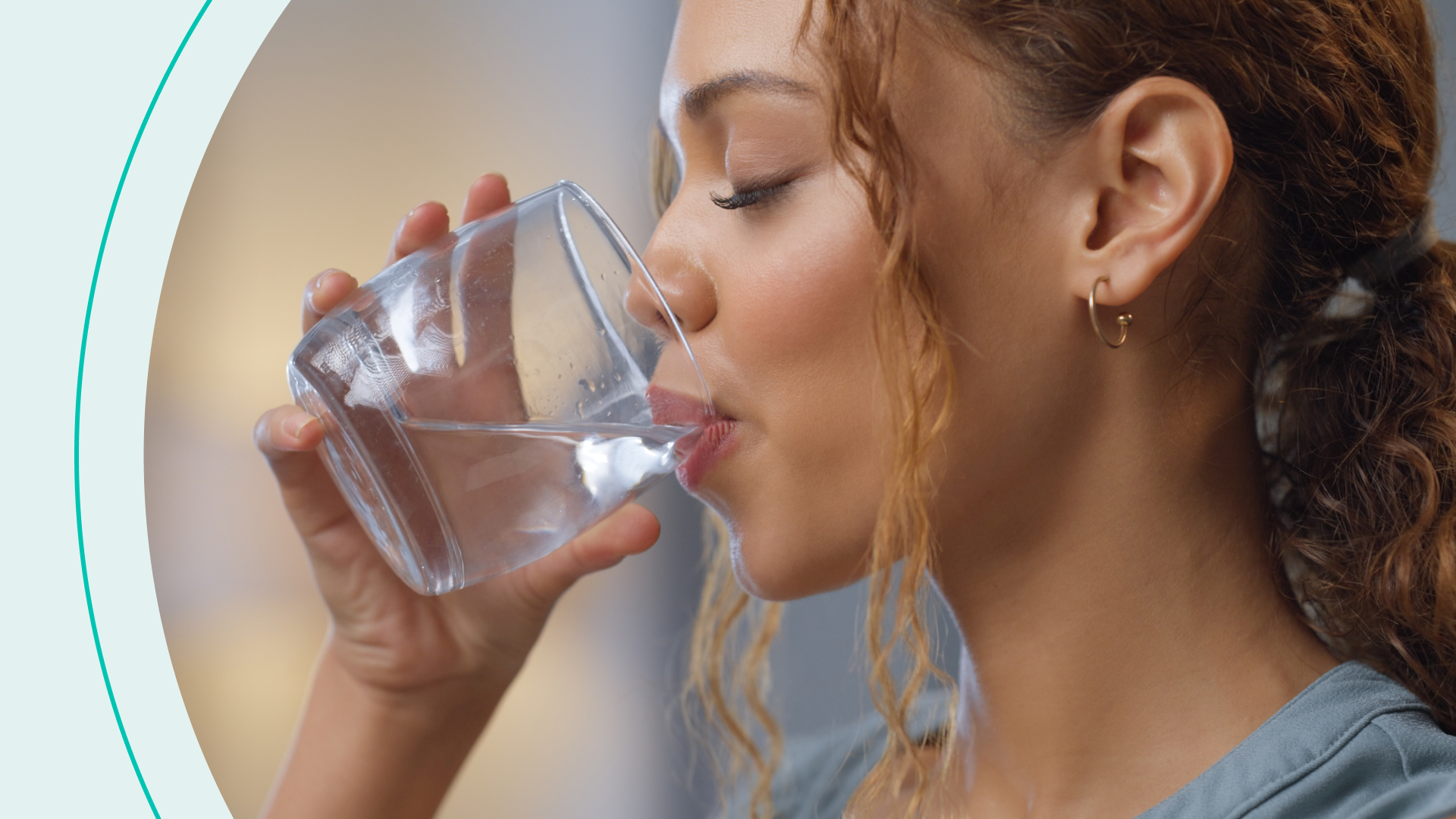 A woman drinking a glass of water
