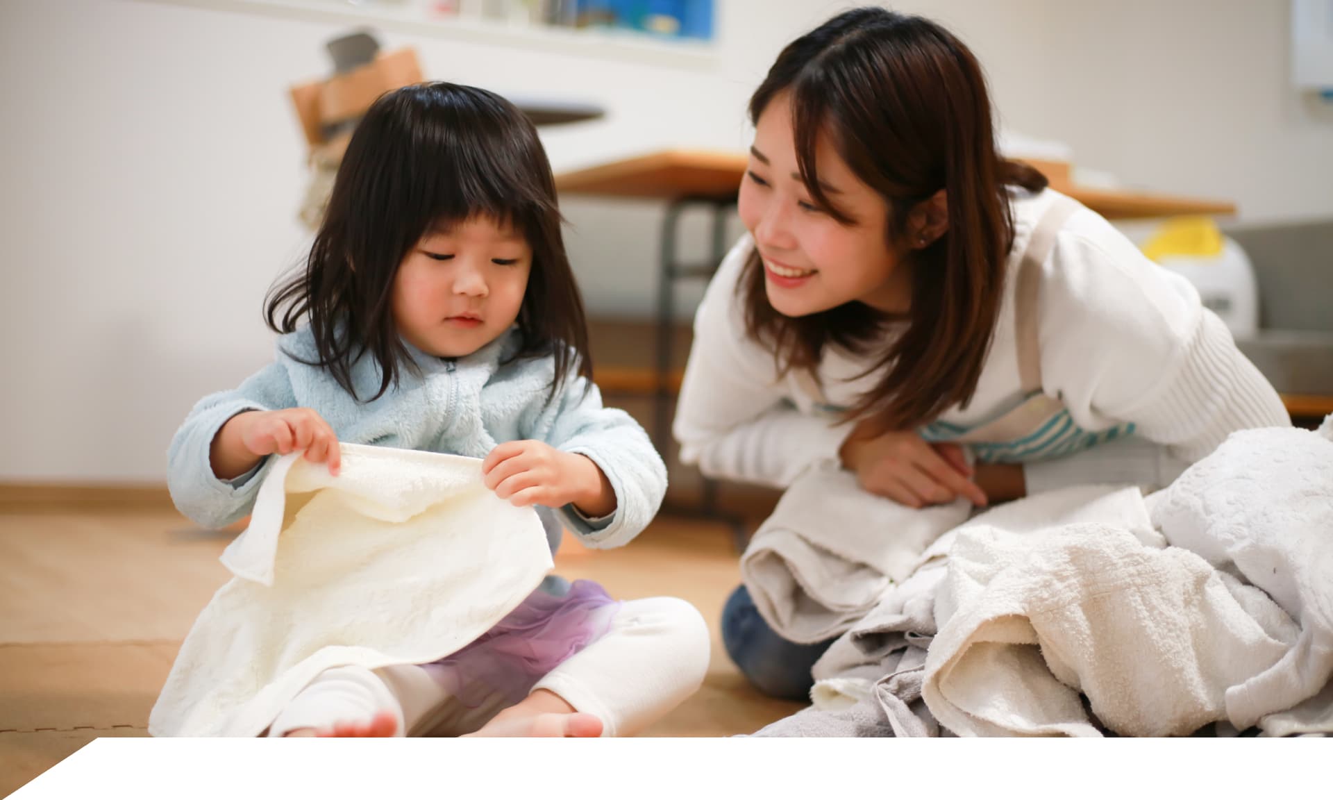 mom and daughter folding laundry