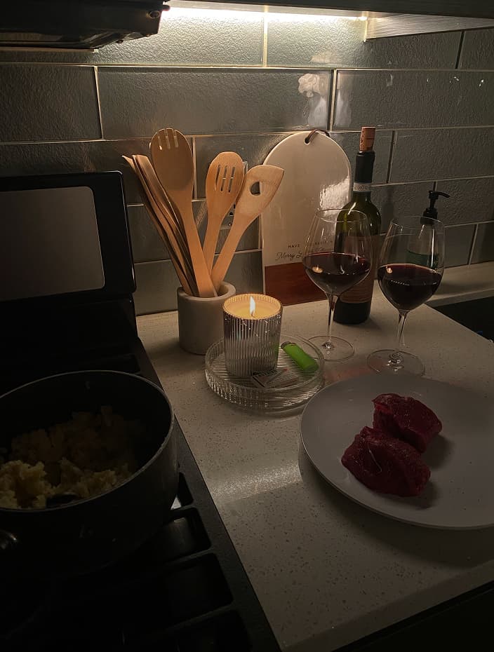 kitchen counter with candle and utensils