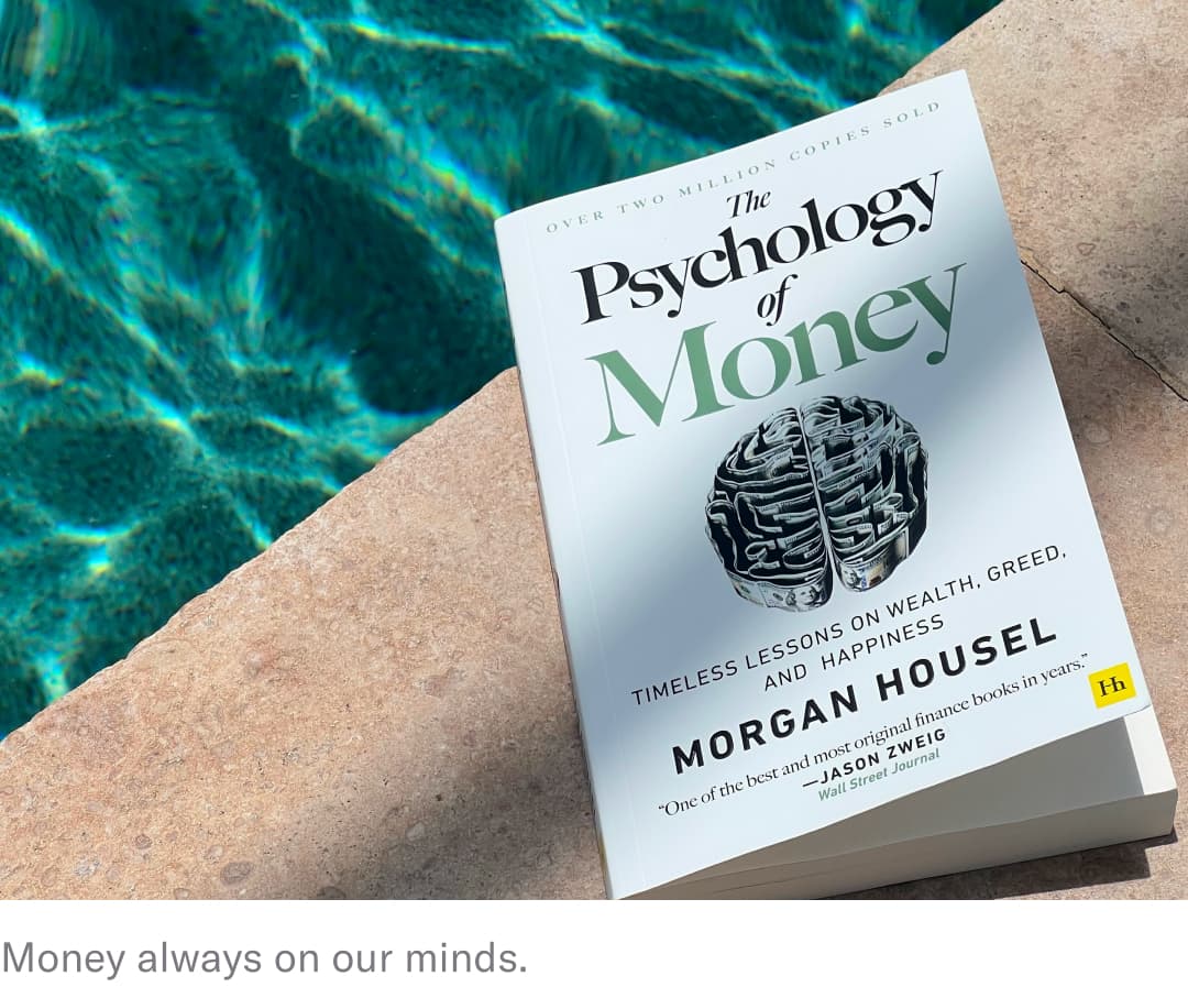 psychology of money book next to pool