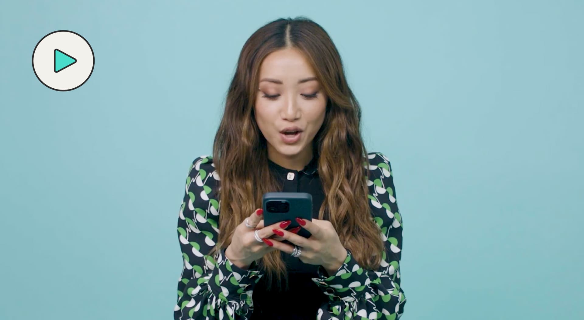 Brenda Song texting with theskimm