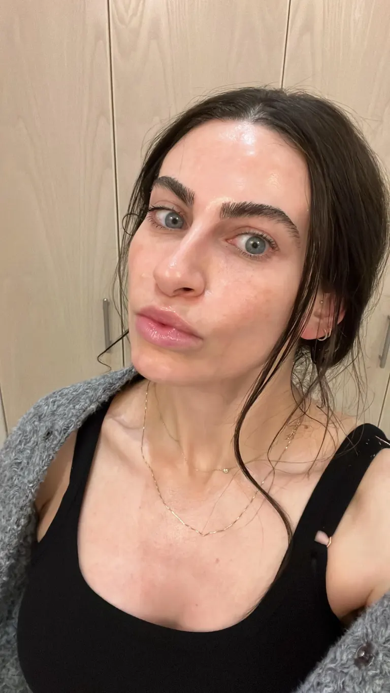 Woman taking selfie with dewy skin