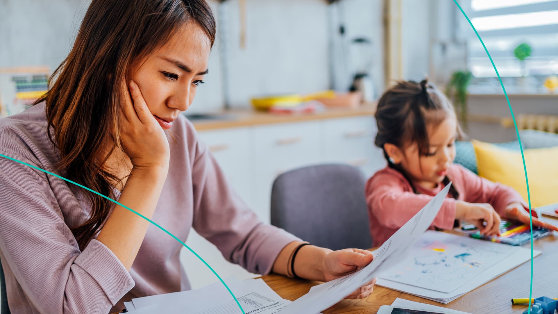 woman checking statement while young daughter plays