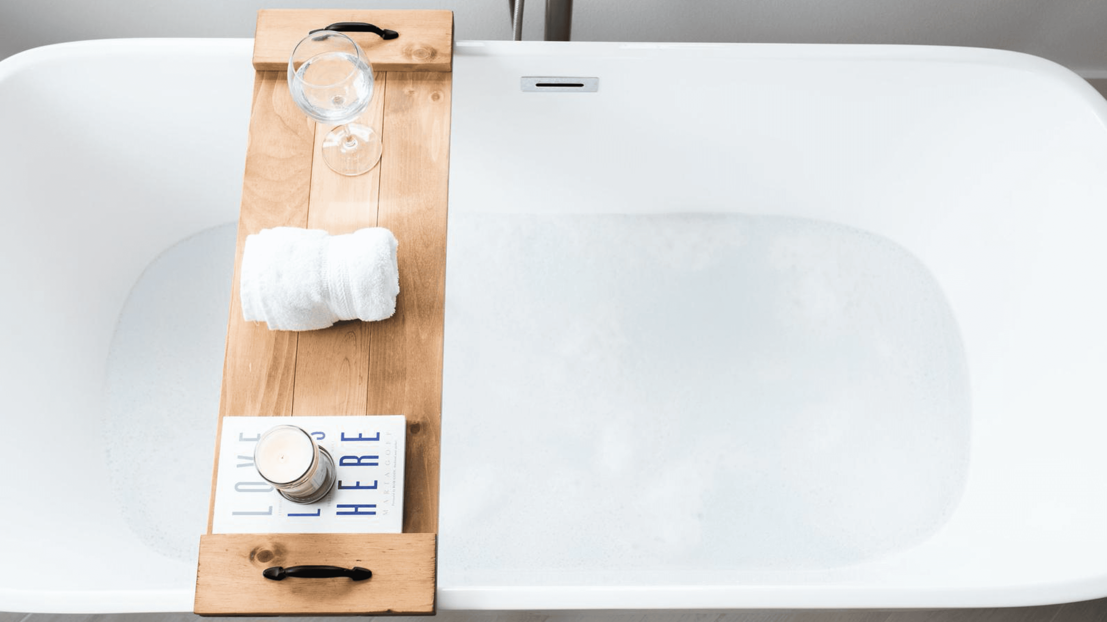 bathtub caddy to hold your book, glass, and a few personal items while you soak