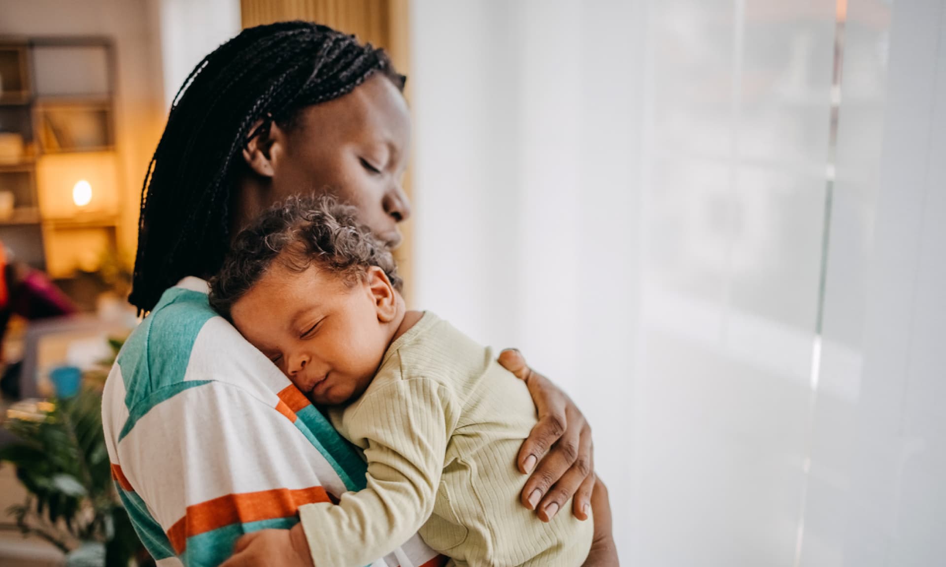 mom holding sleeping son