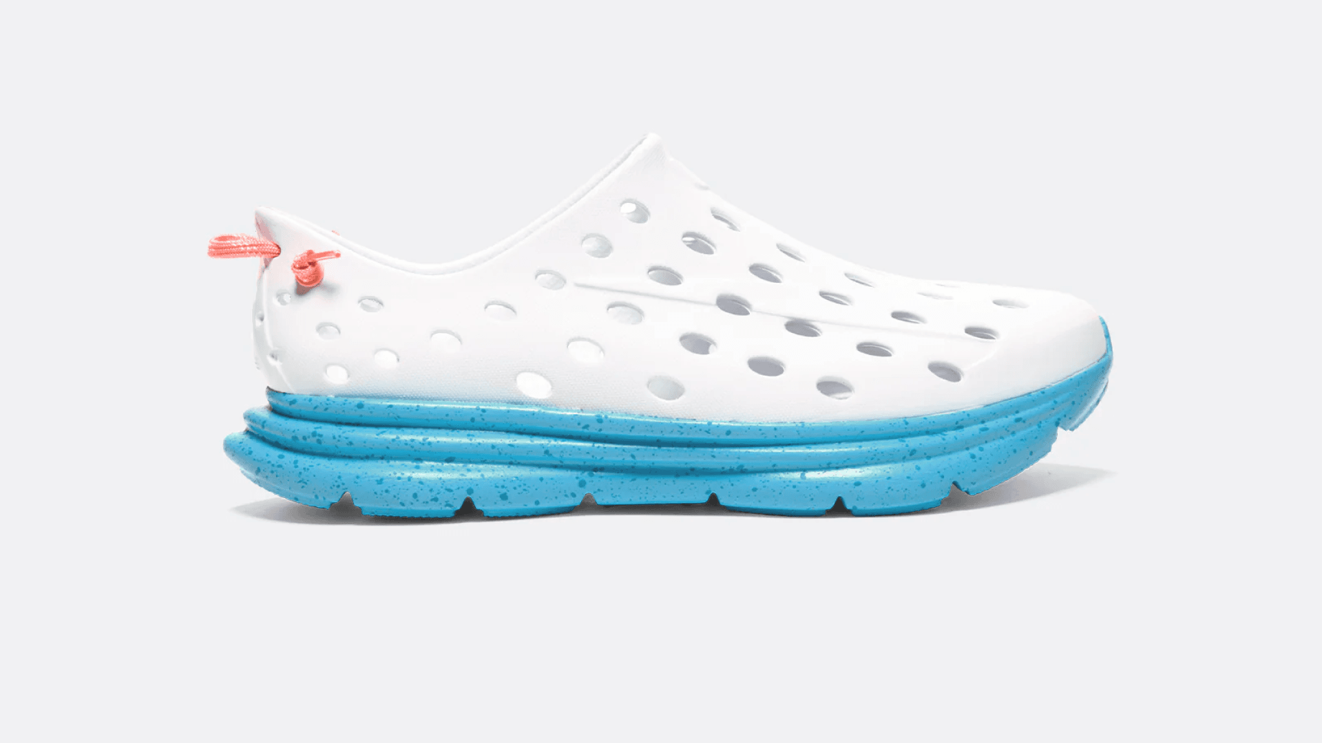 White shoes with holes and speckled teal sole
