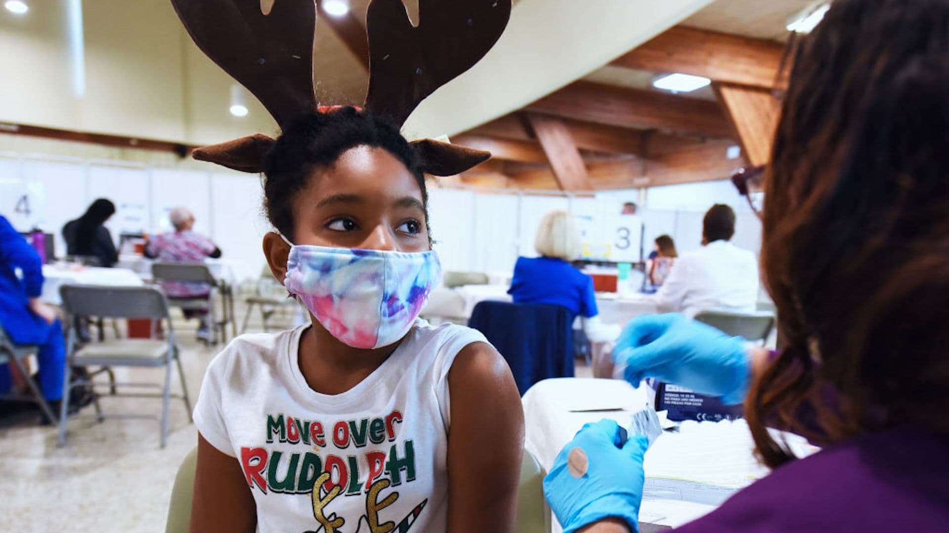 Health worker prepares to administer a dose of Pfizer COVID-19 vaccine to a young girl in Florida.