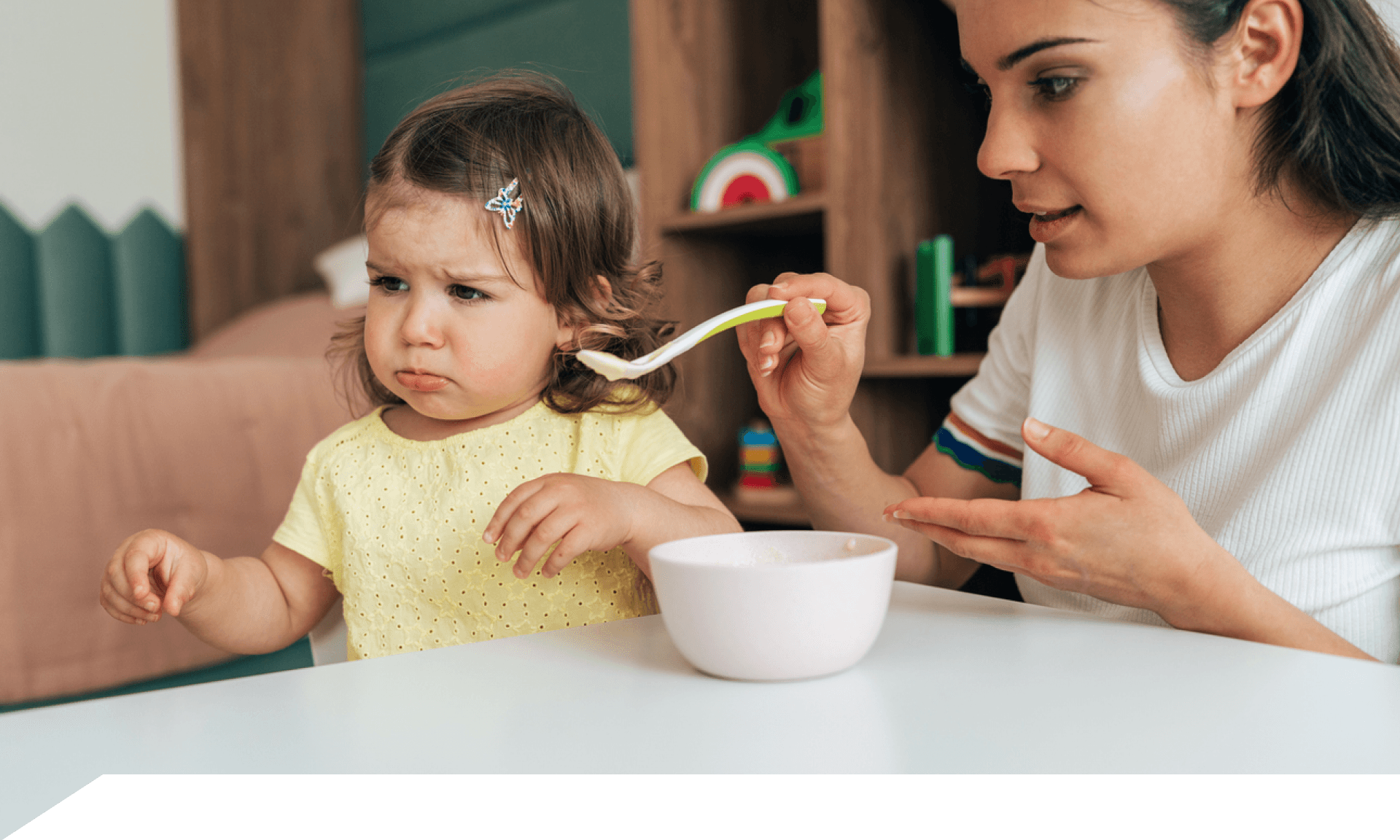 Mom trying to feed child 