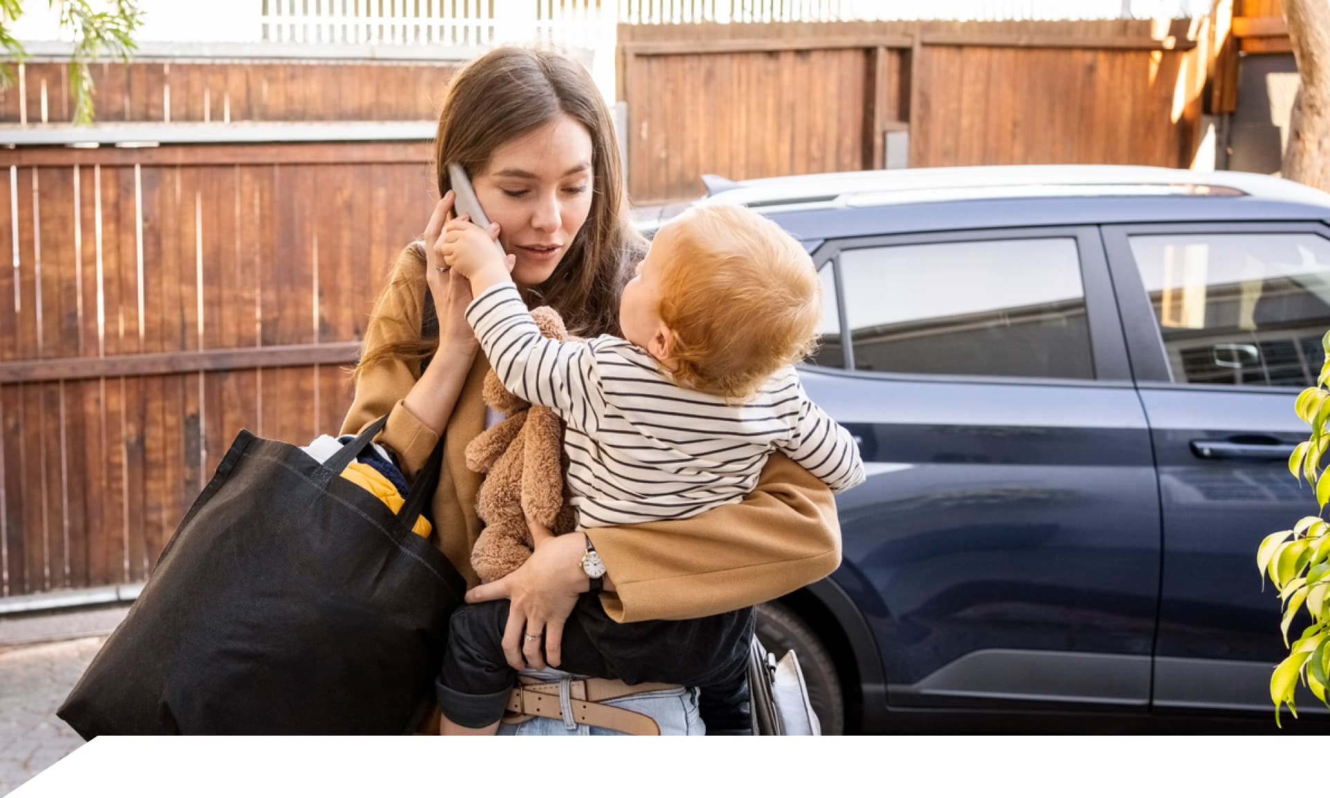 busy mom on the phone holding child