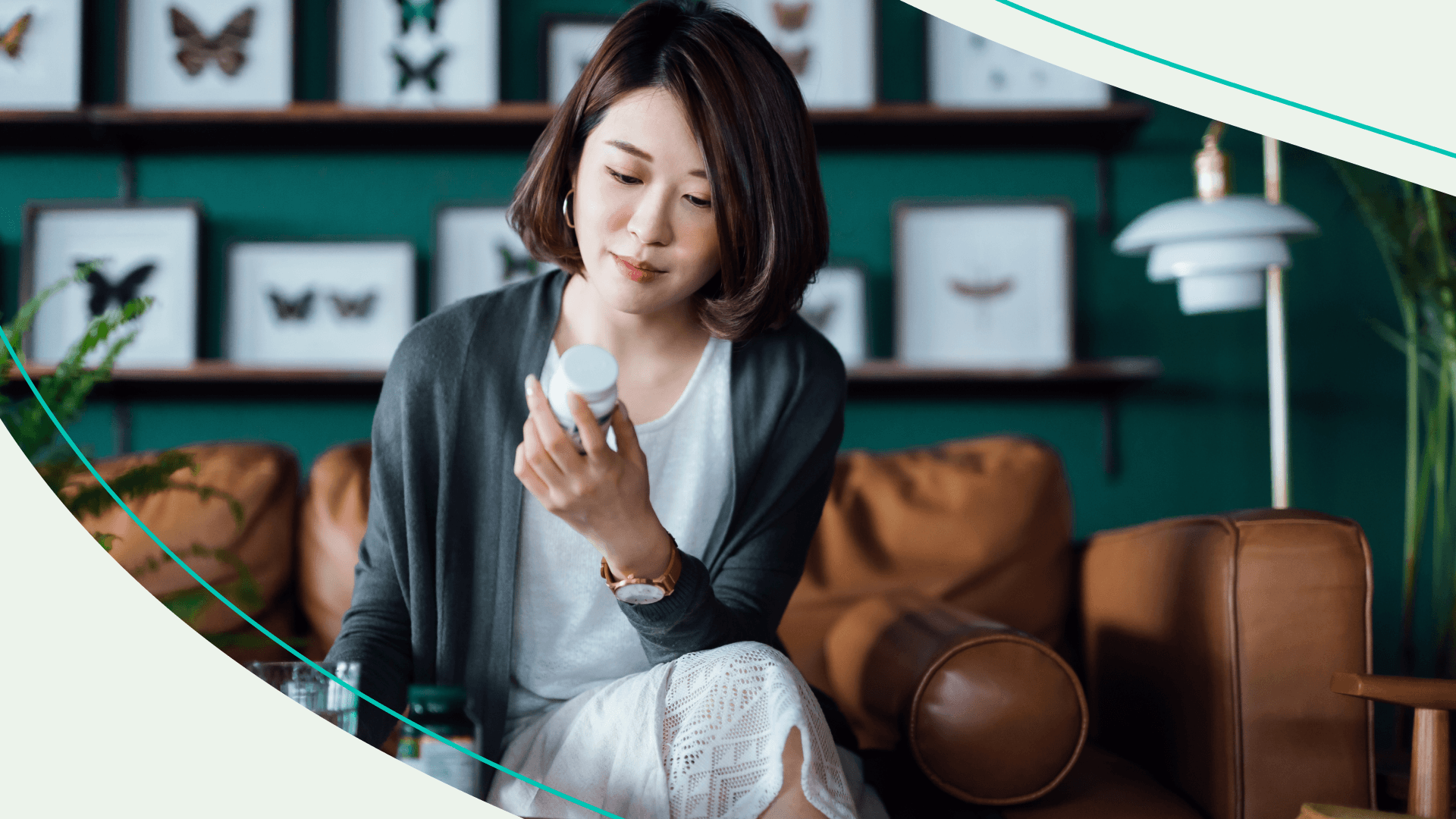 Woman looks at probiotic pill bottle