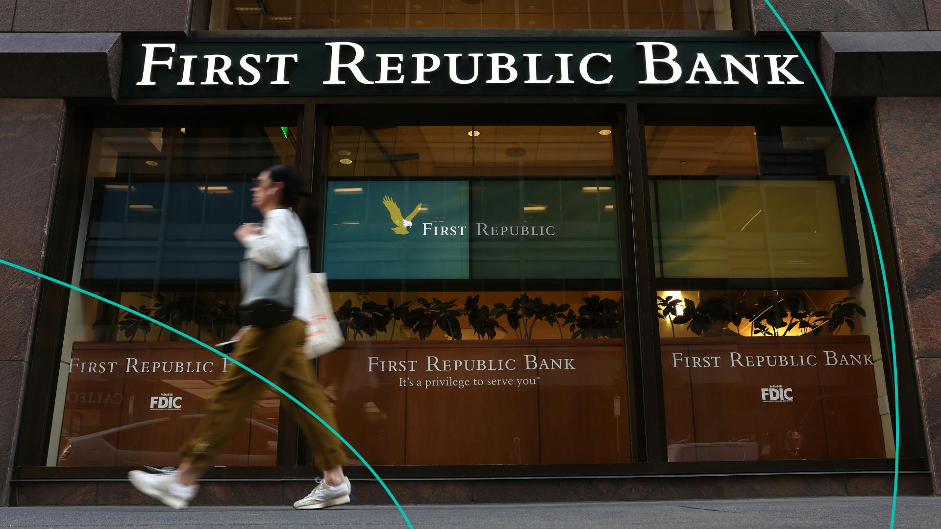A pedestrian walks by a First Republic bank 