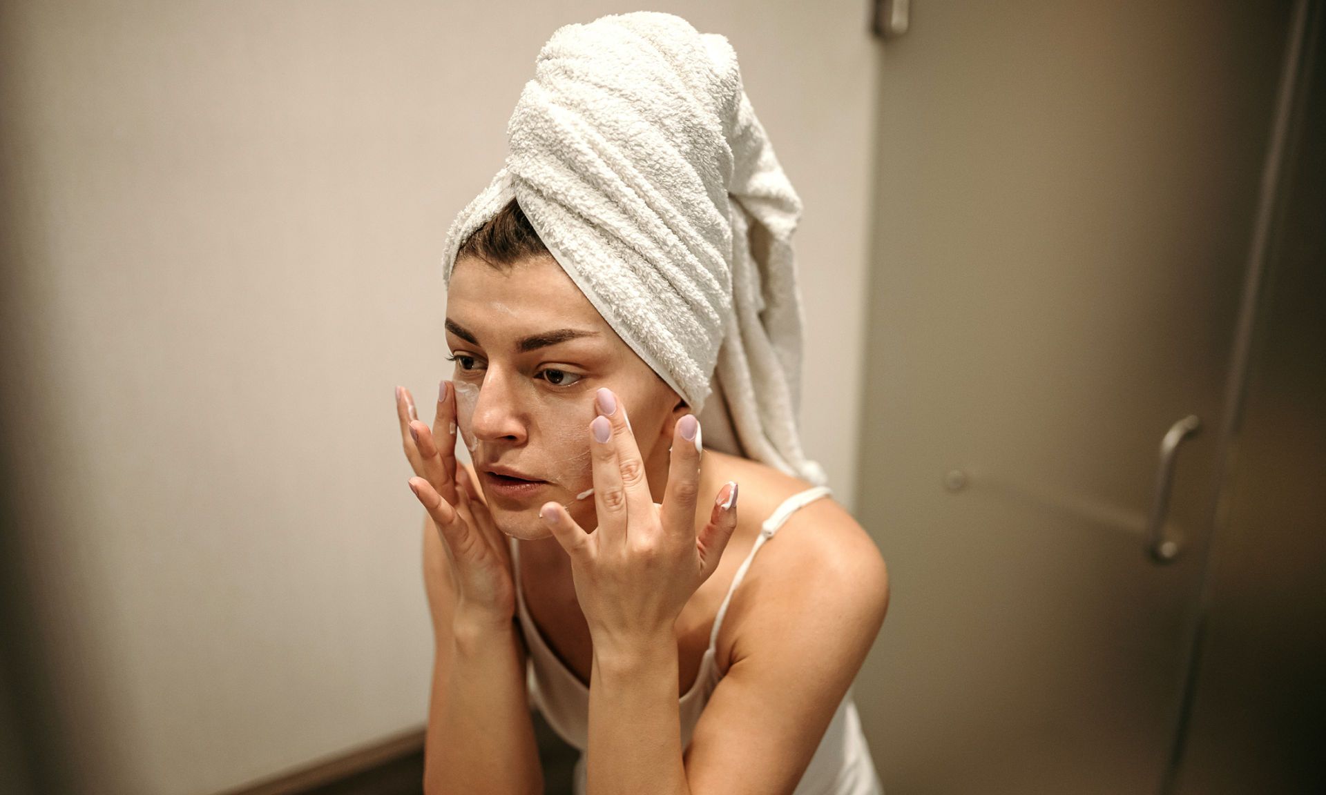 Woman putting on eye cream