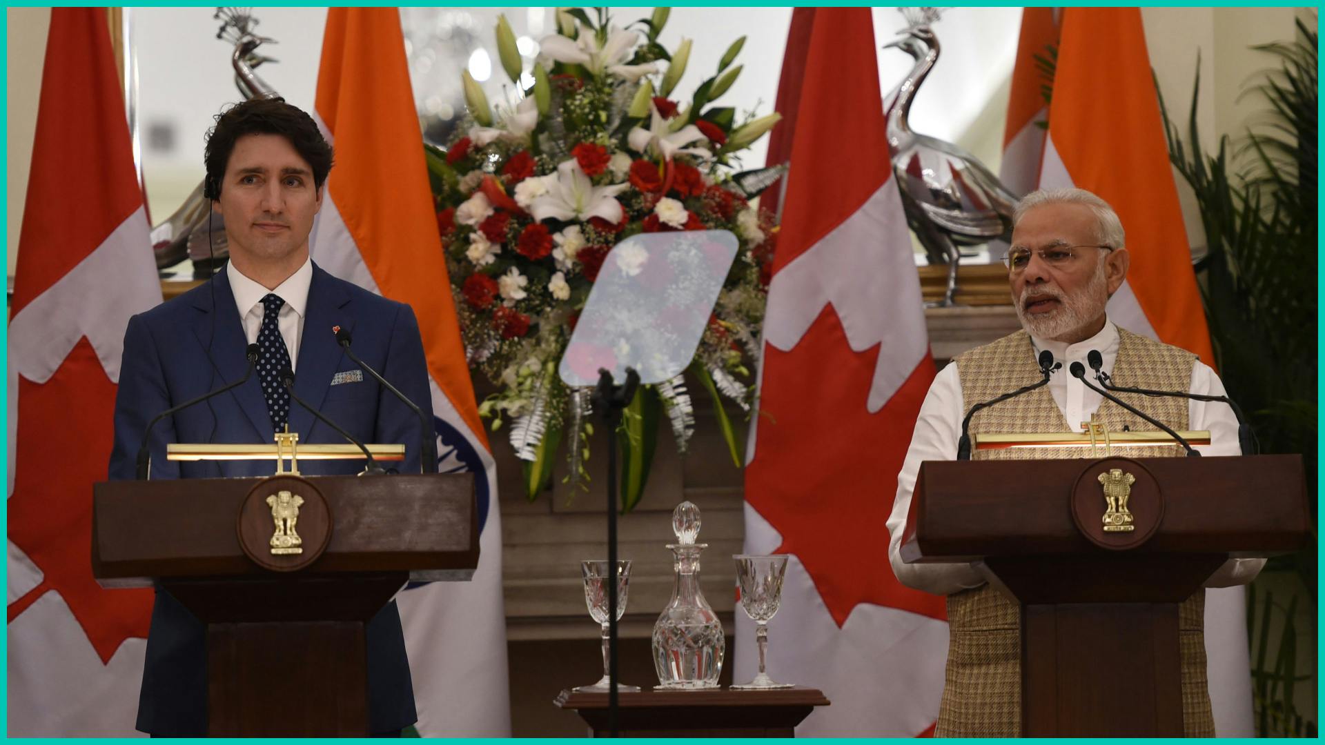 Indian Prime Minister Narendra Modi (R) speaks as Canadian Prime Minister Justin Trudeau looks on at a joint press statement at Hyderabad House in New Delhi