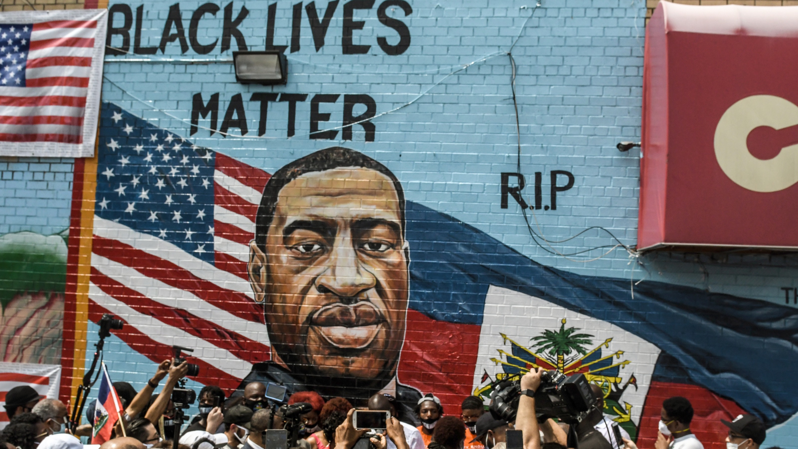 A mural painted by artist Kenny Altidor depicting George Floyd is unveiled on a sidewall of CTown Supermarket on July 13, 2020 in the Brooklyn borough New York City.