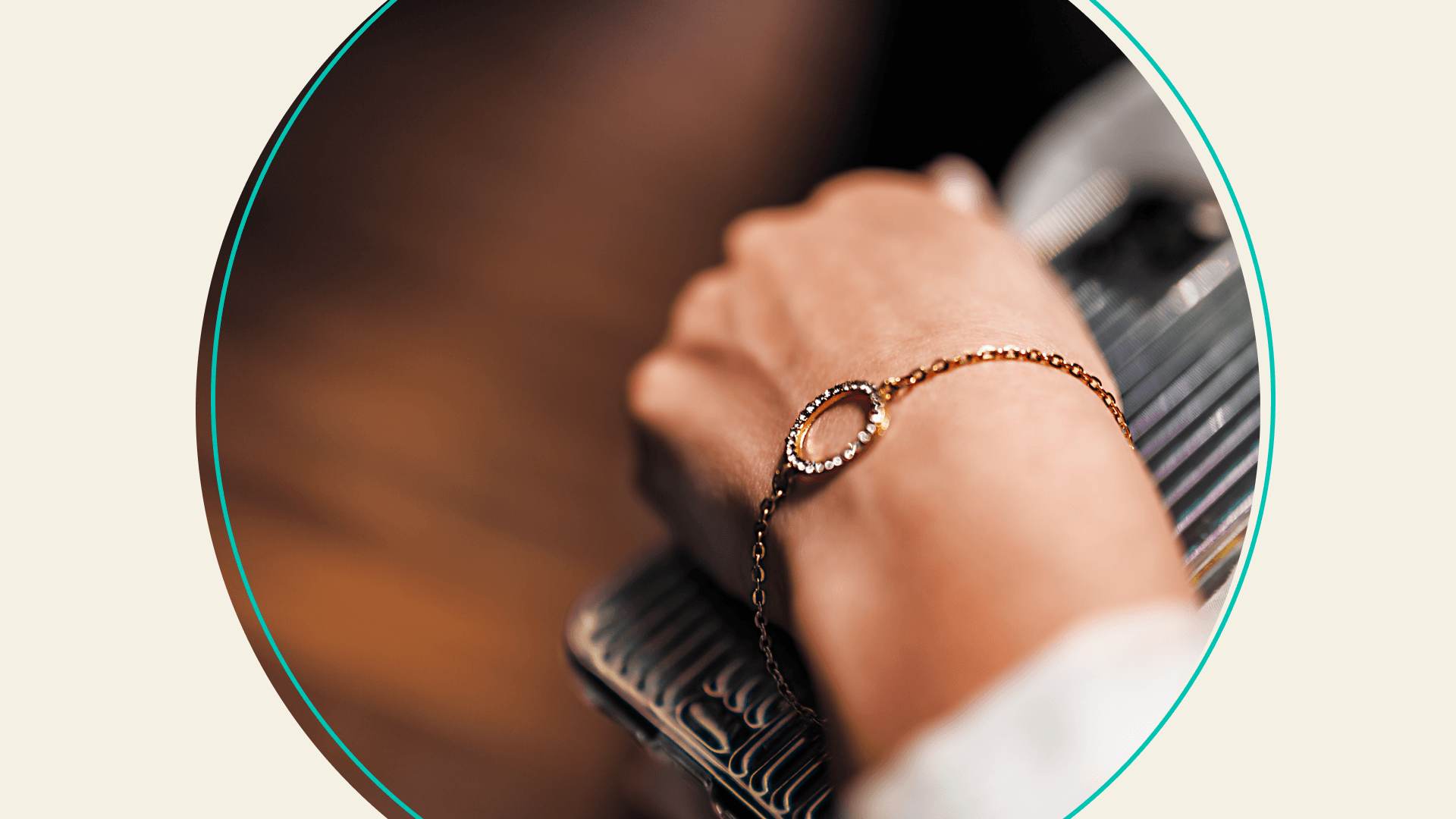 A person's wrist wearing a gold bracelet