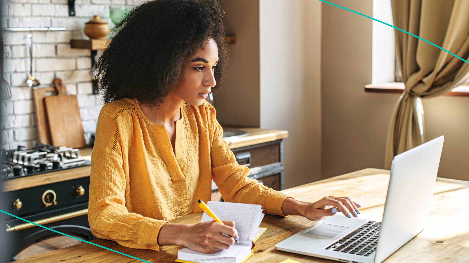 Woman working on computer at kitchen counter
