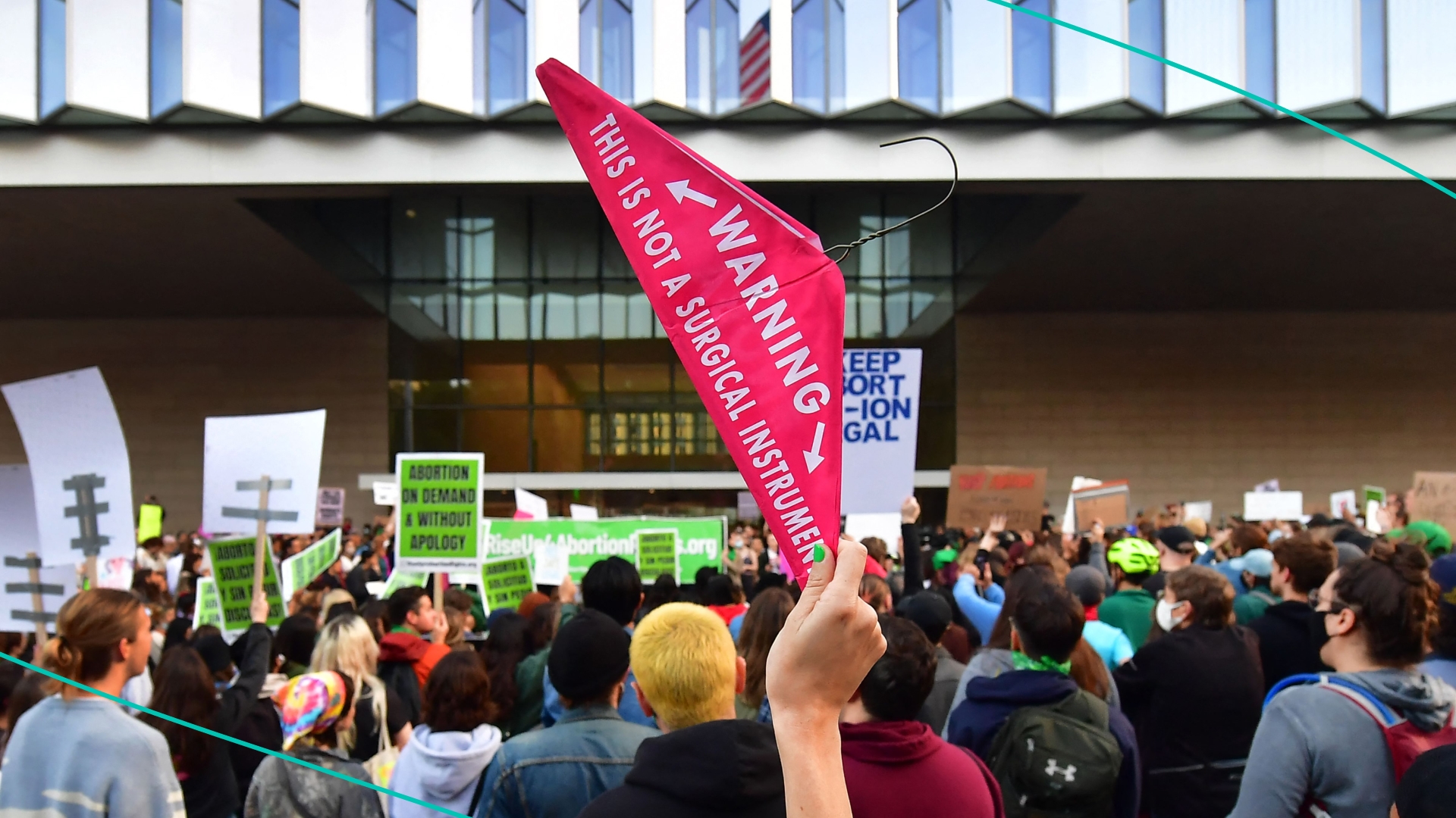 A person holds up a coat hanger, a symbol of the reproductive rights movement