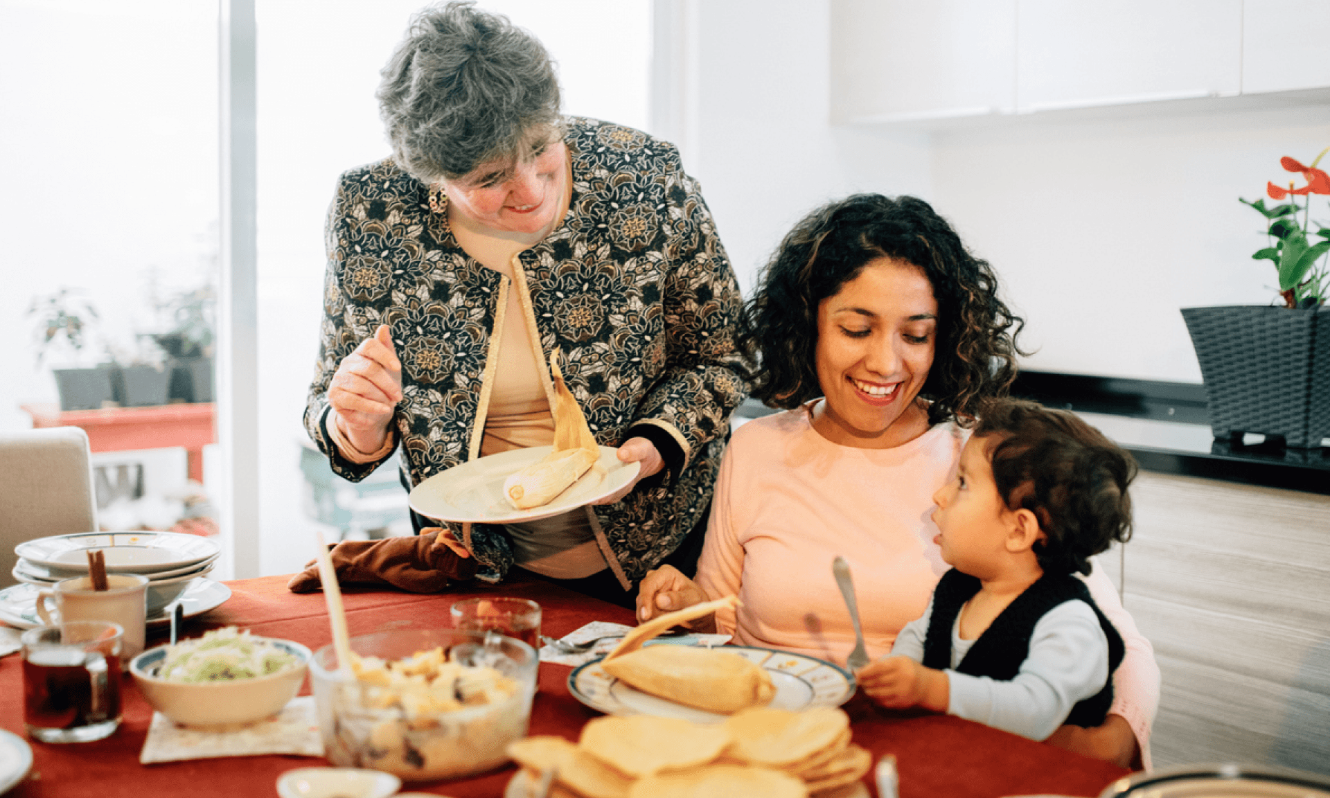 grandmother, mother and kid sitting around table