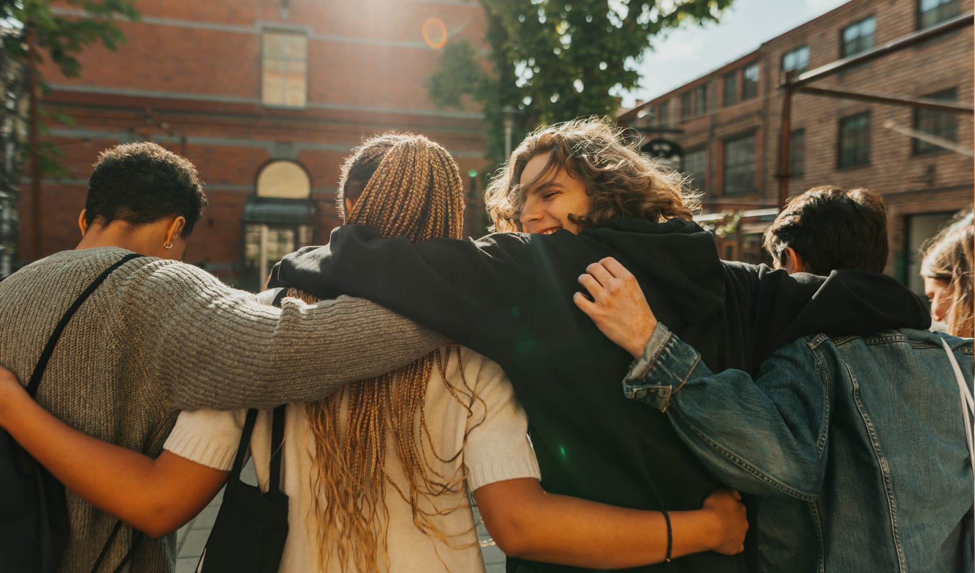 Friends hugging each other in a line