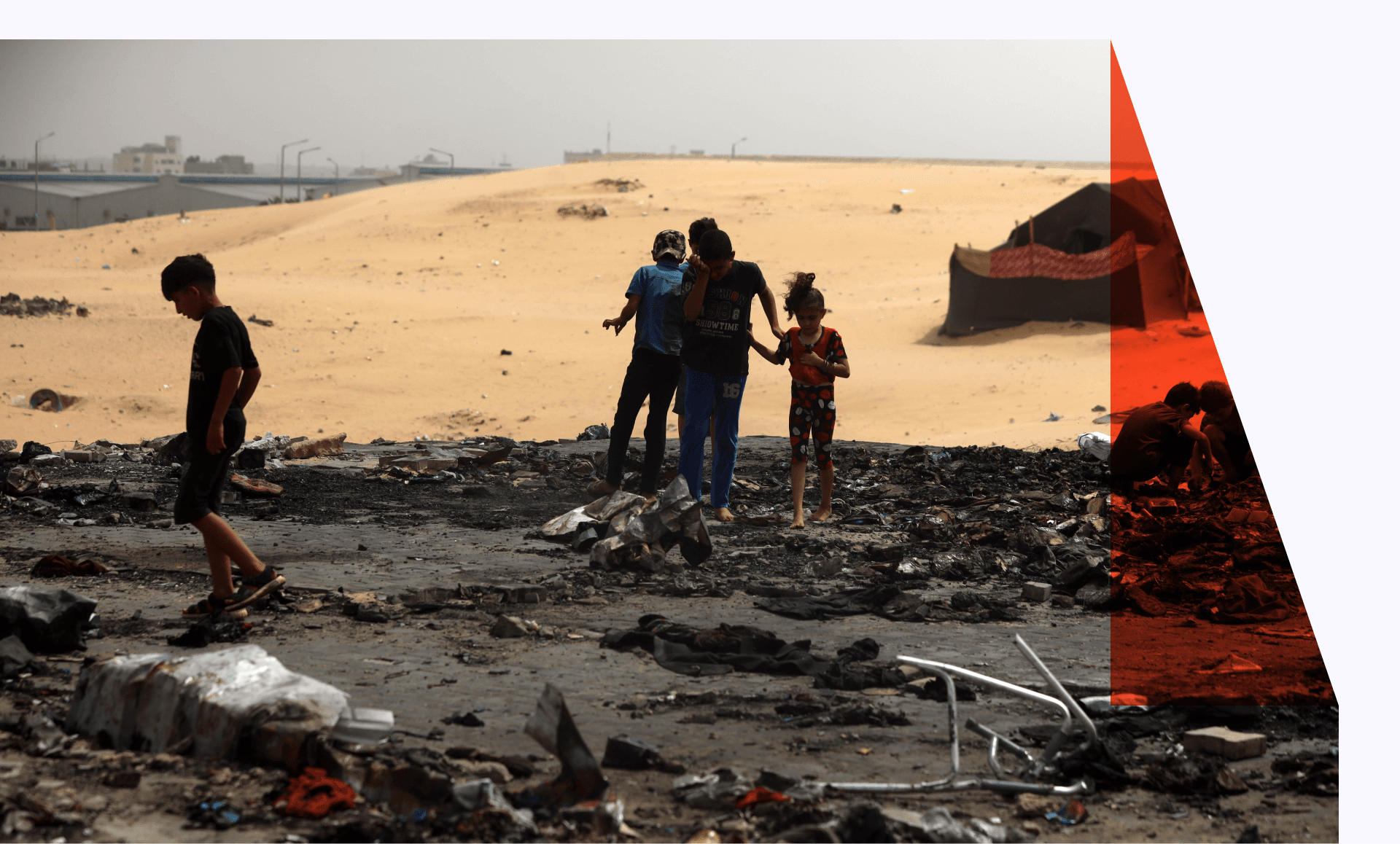 Children in what's left of burned tents in Rafah