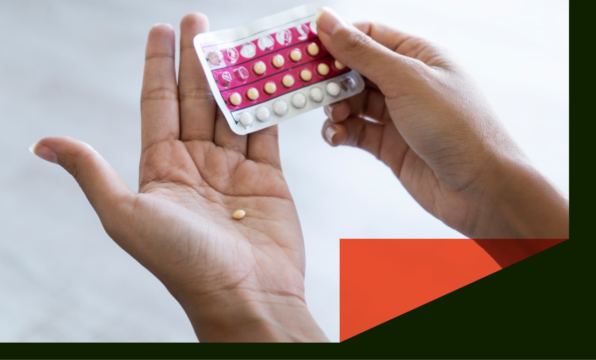 Woman holding birth control pills at home - stock photo