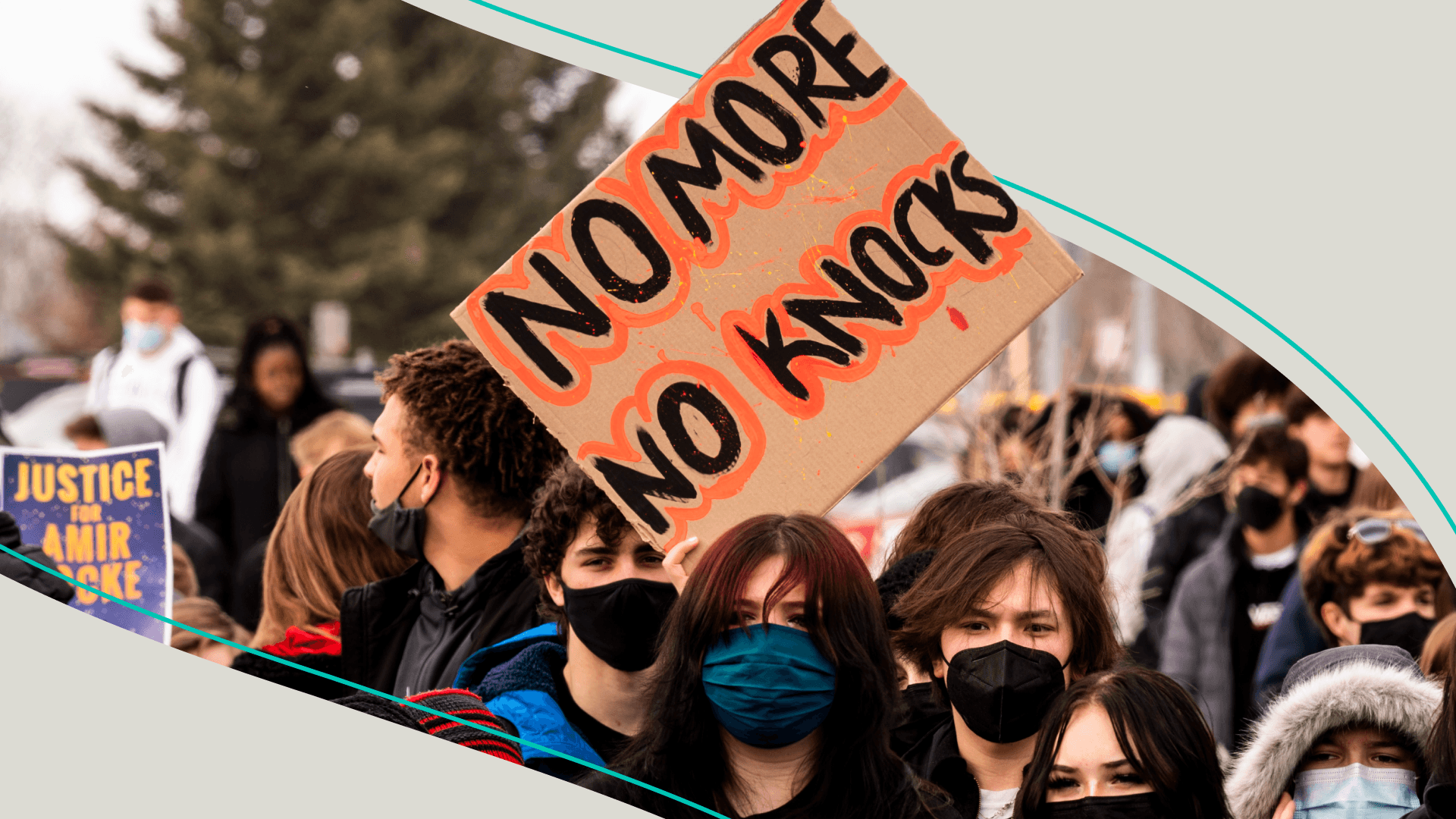 Protester holding 'No More No Knocks' sign