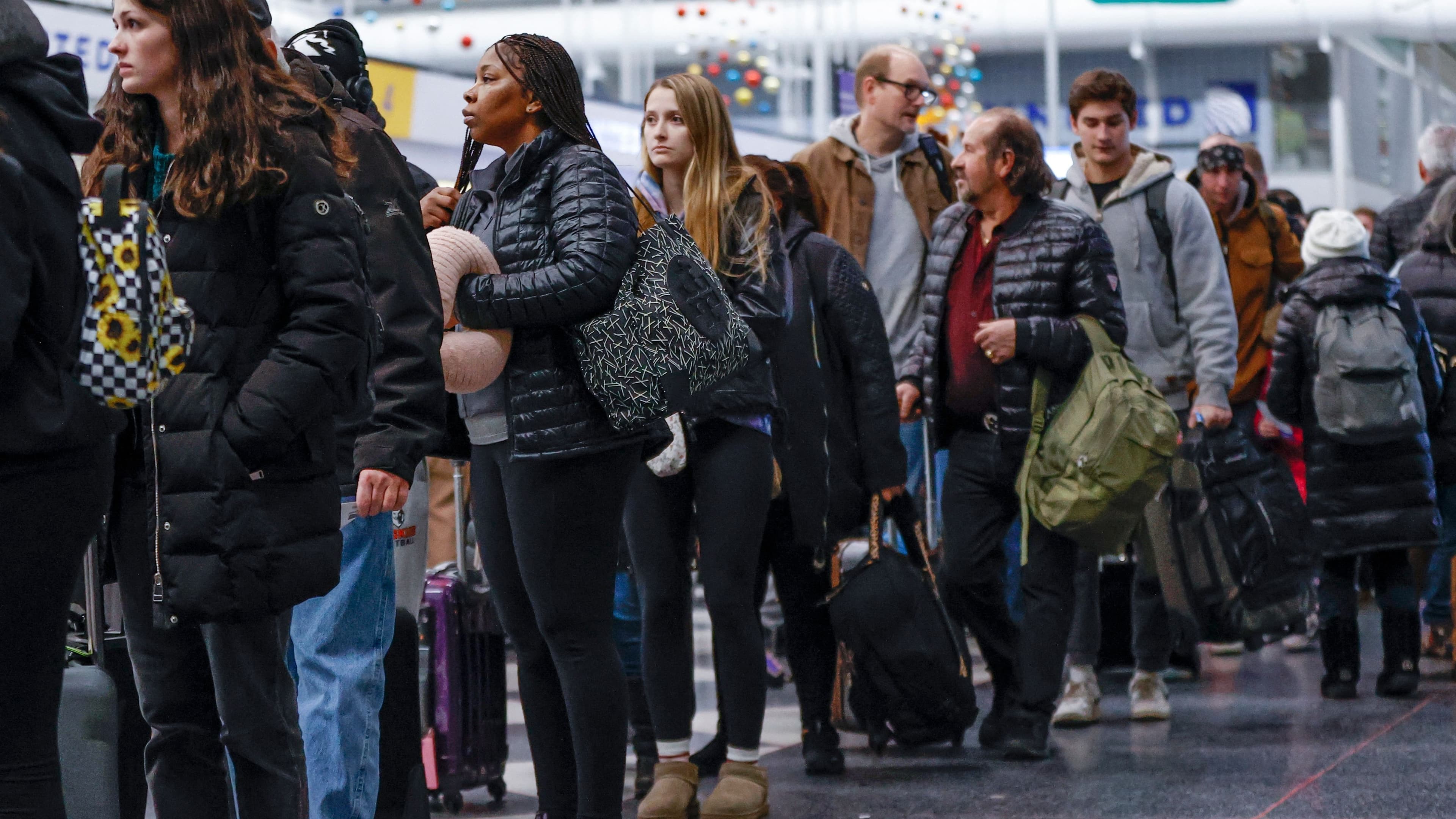 people standing in line at the airport