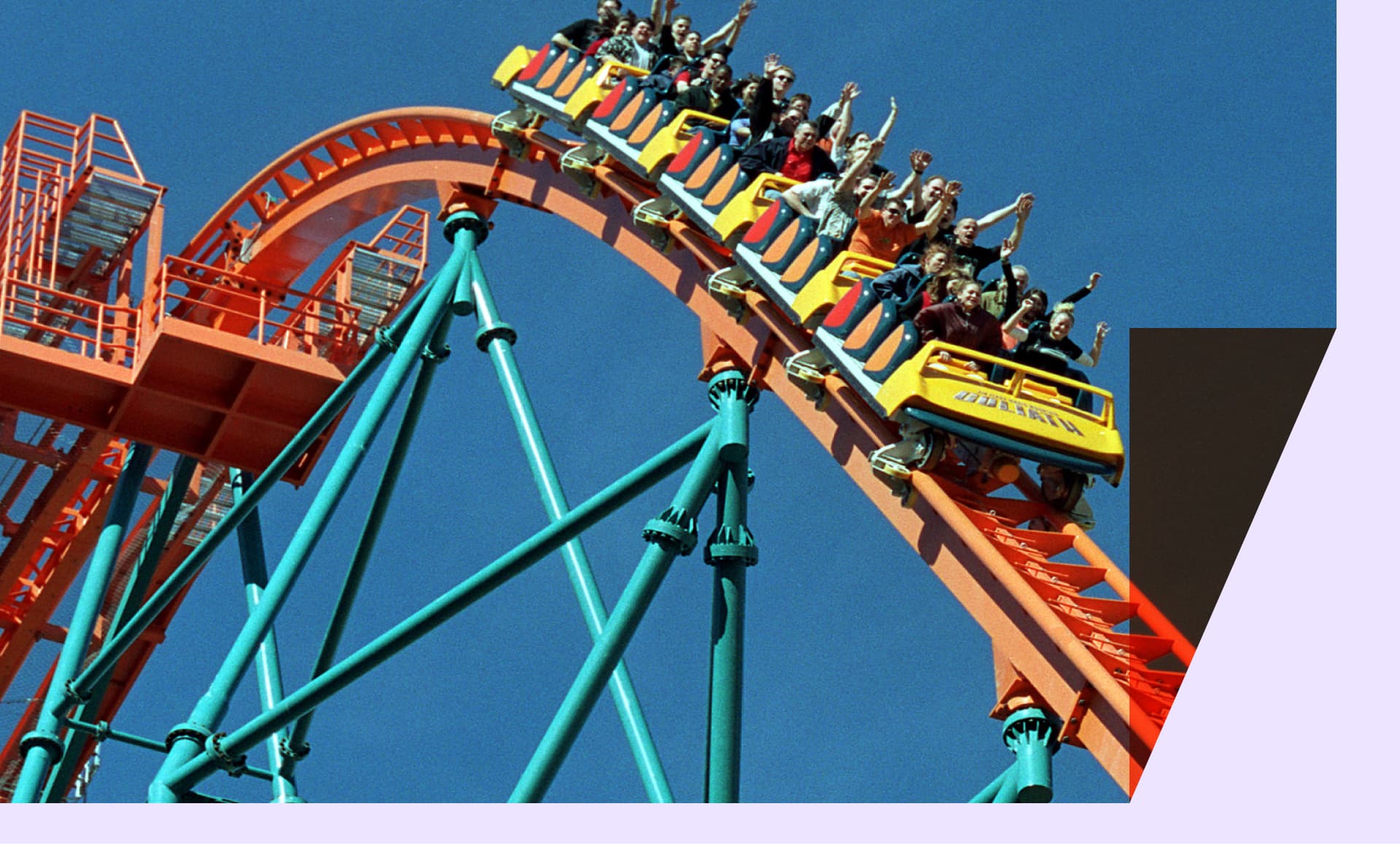 Roller coaster riders throw their hands in the air as they ride "Goliath," a roller coaster at Six Flags Magic Mountain.