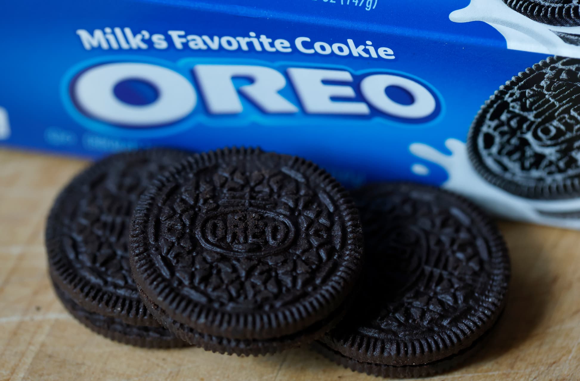 three oreo cookies sitting next to their packaging