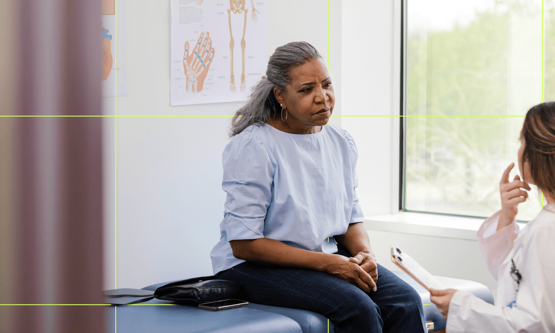 A woman sitting and talking with her doctor