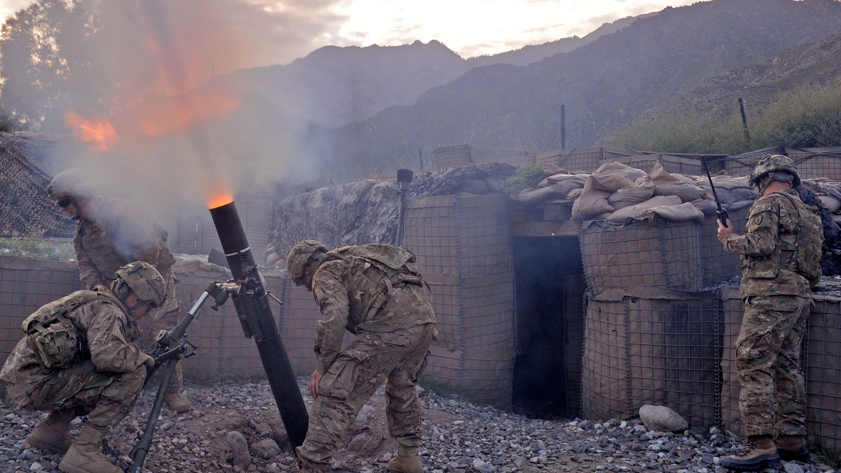 US army soldiers from Bravo company 2nd Batallion 27th Infantry Regiment fire 120 mm mortar rounds towards insurgent positions at Outpost Monti in Kunar province, on September 17, 2011.