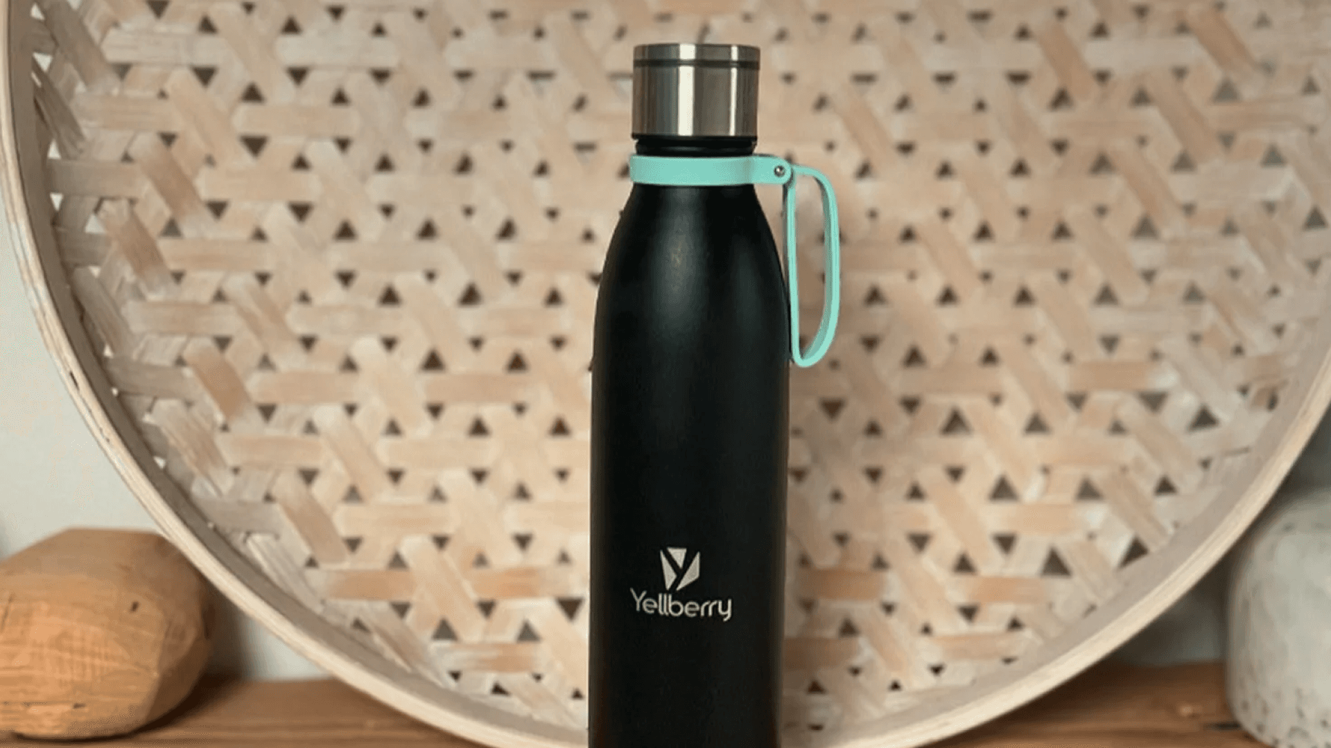 Black self-cleaning water bottle with teal strap