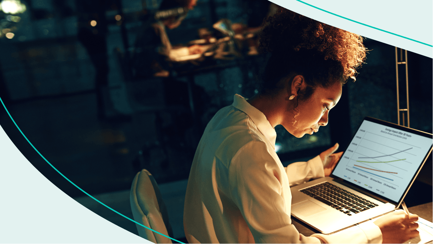woman looking at laptop in dark room