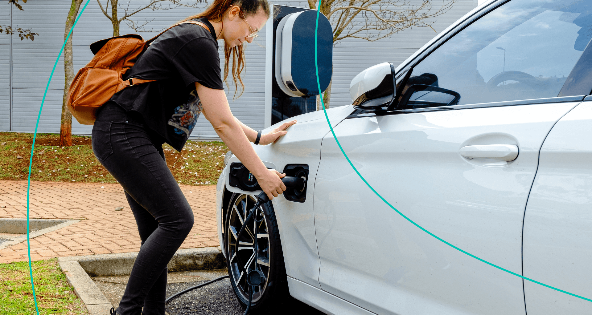 A woman chargers her EV