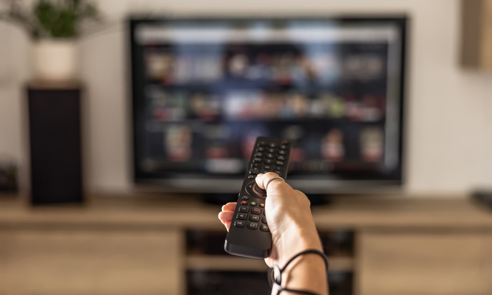 A remote control in front of a TV