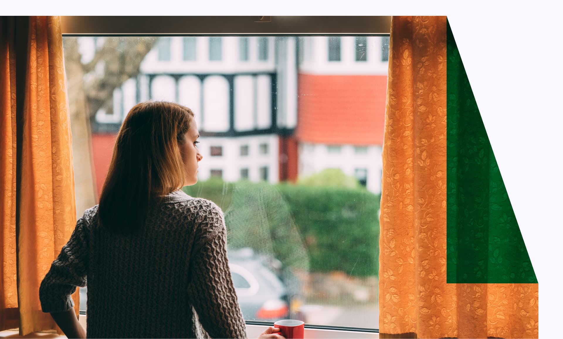 Woman staying home for safety during coronavirus pandemic and observing empty city