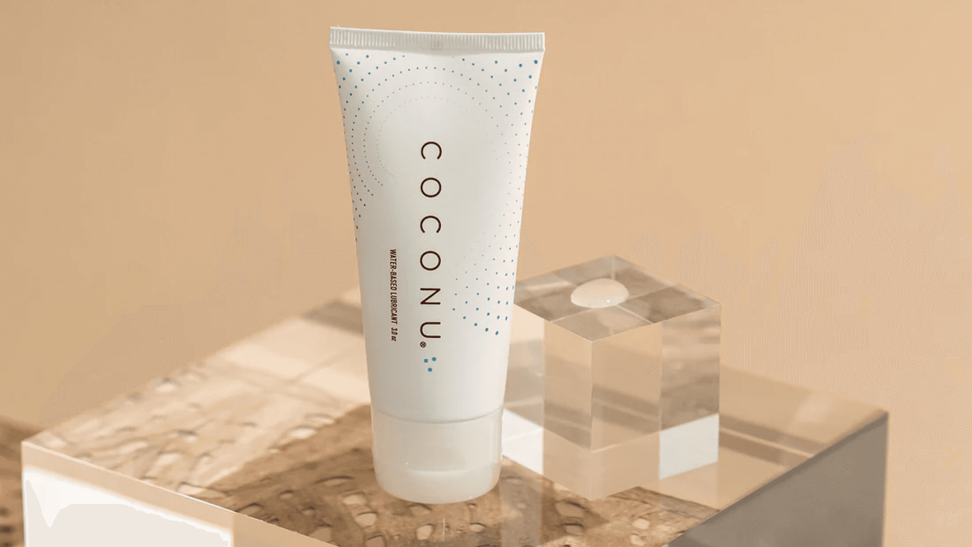 White tube of lube on glass block