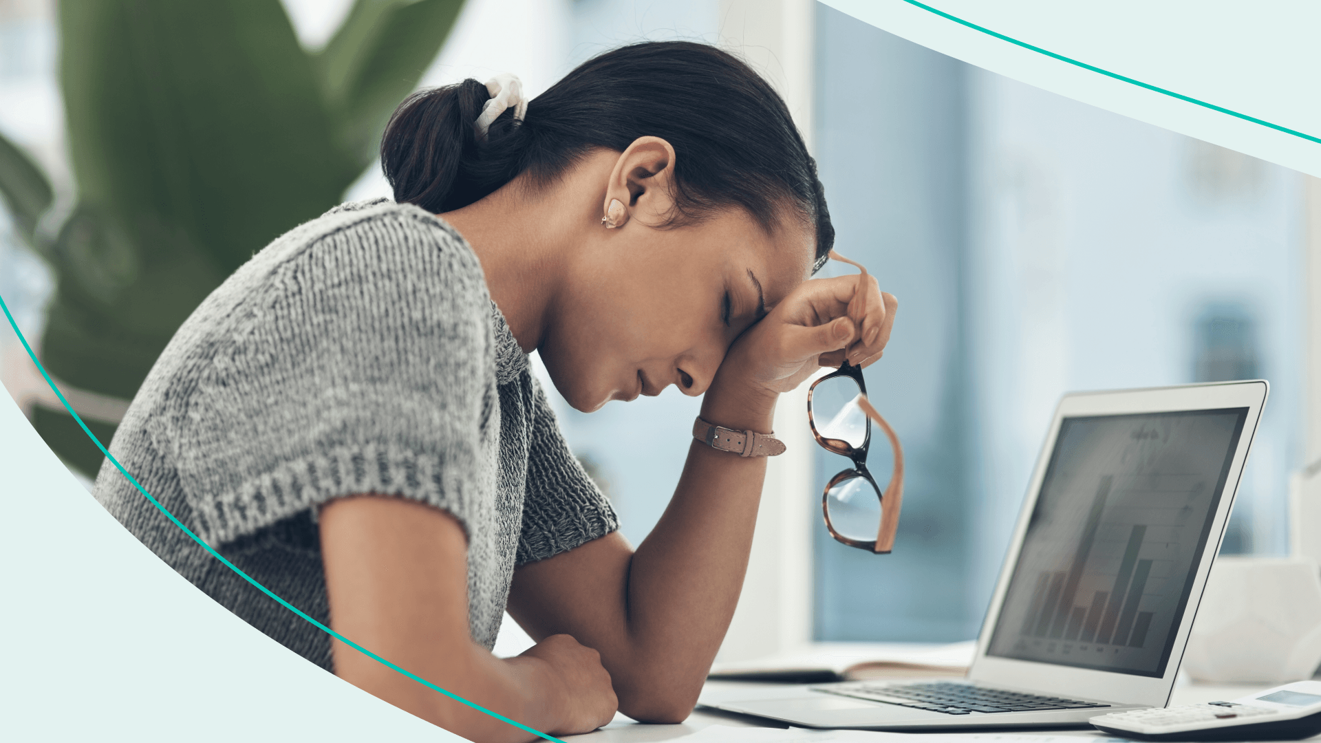 A woman at her laptop resting her head on her wrist