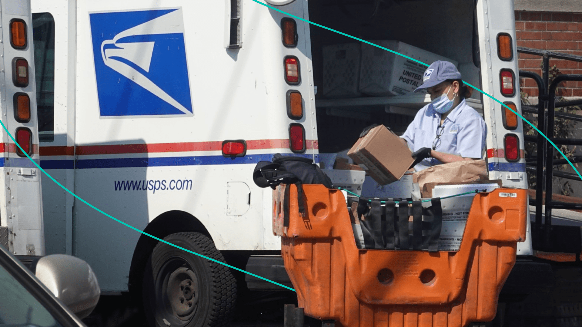 A postal worker loads a delivery truck