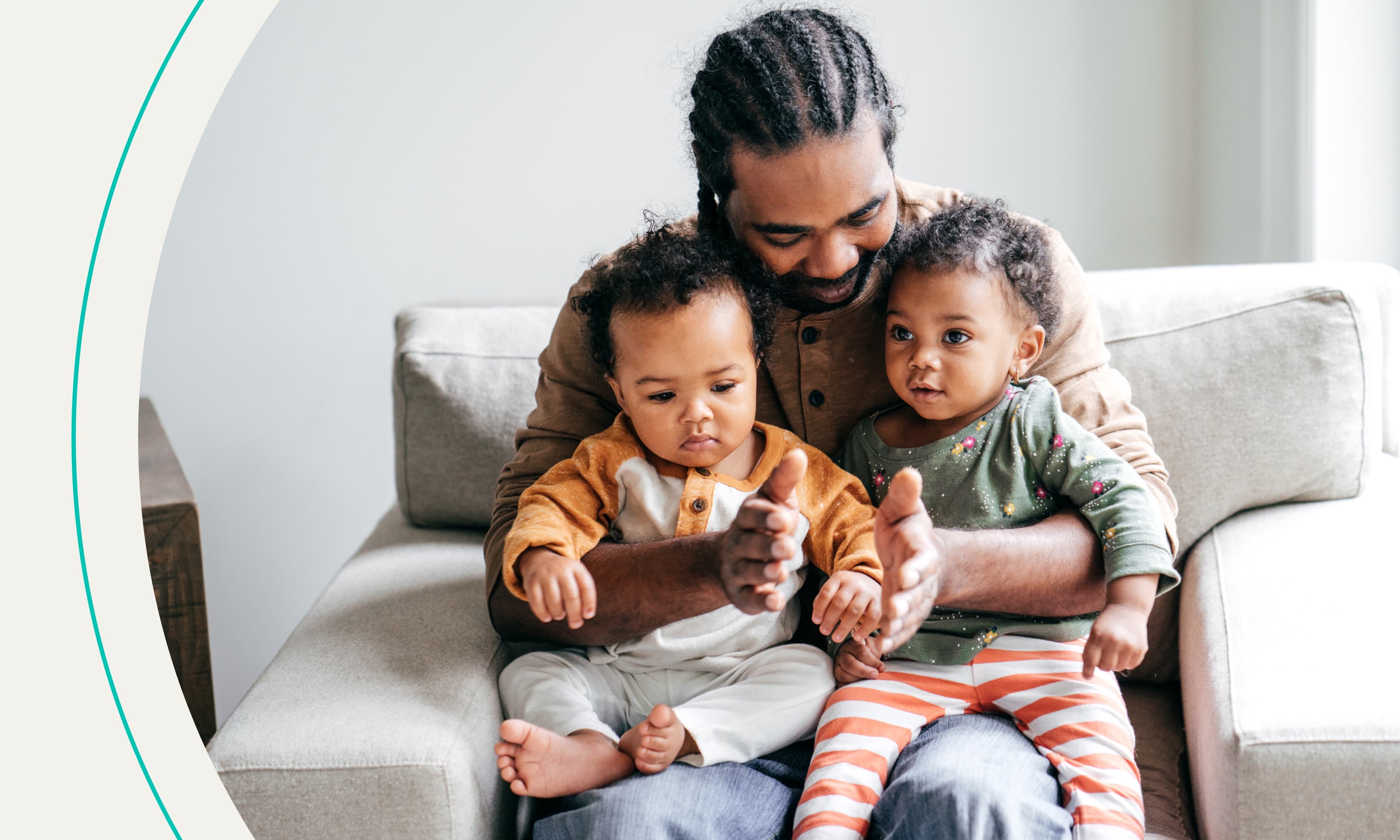 dad holding two babies