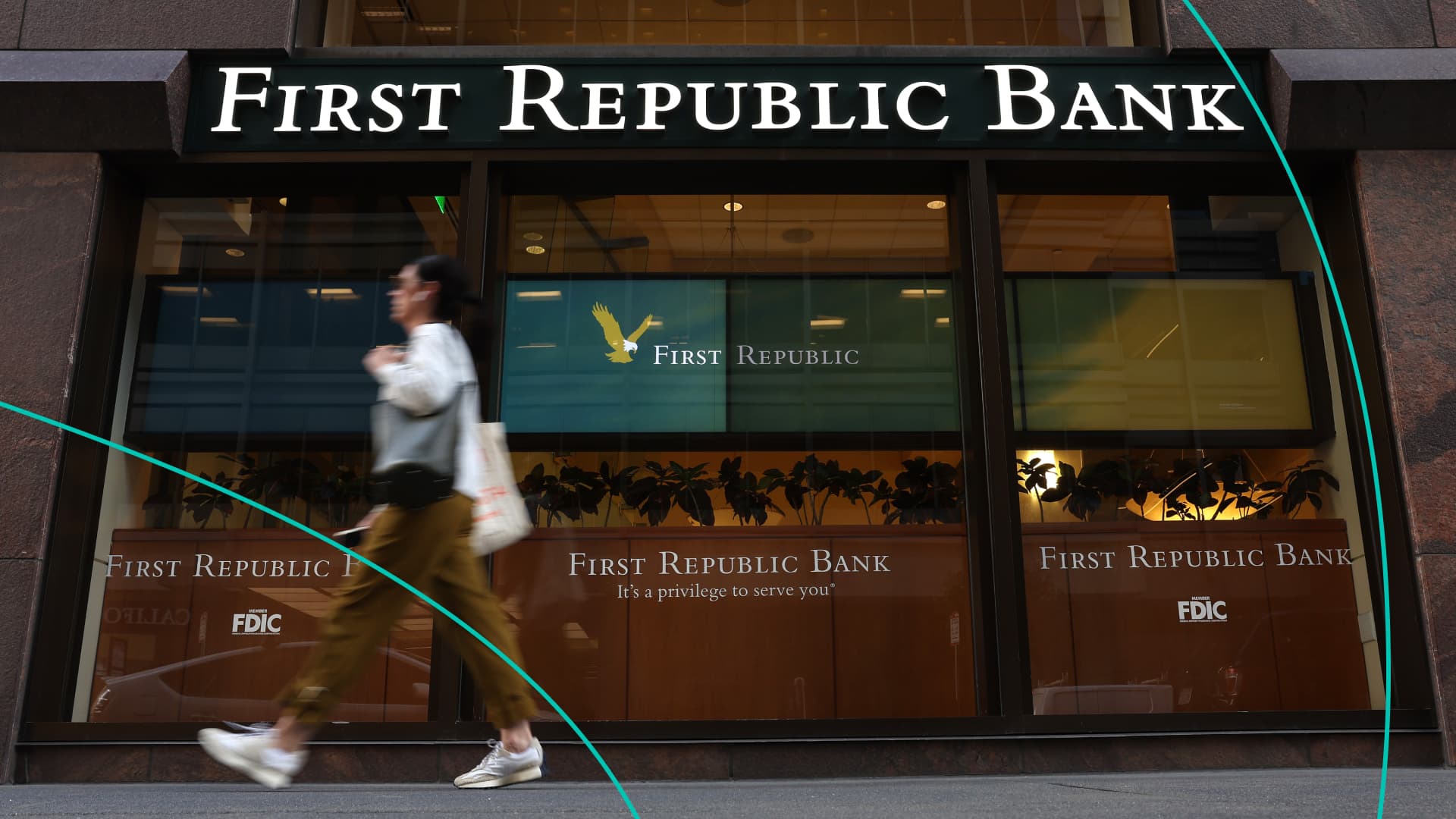 A pedestrian walks by a First Republic bank
