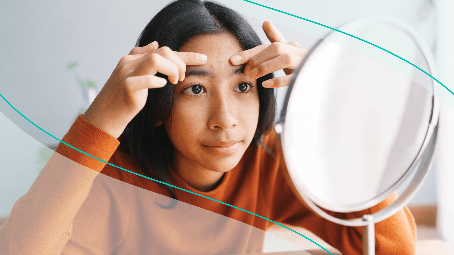 Woman pinching a pimple on her forehead