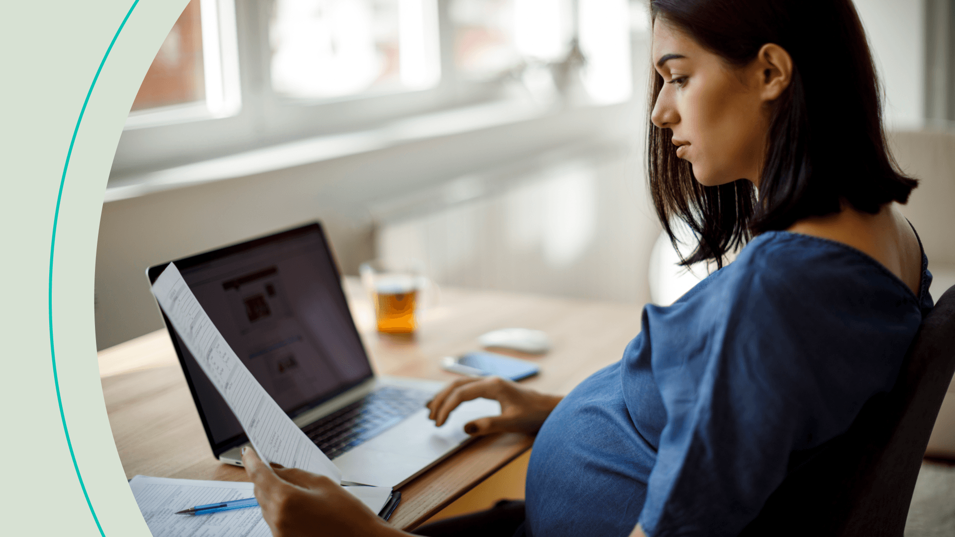 Pregnant woman looking at document