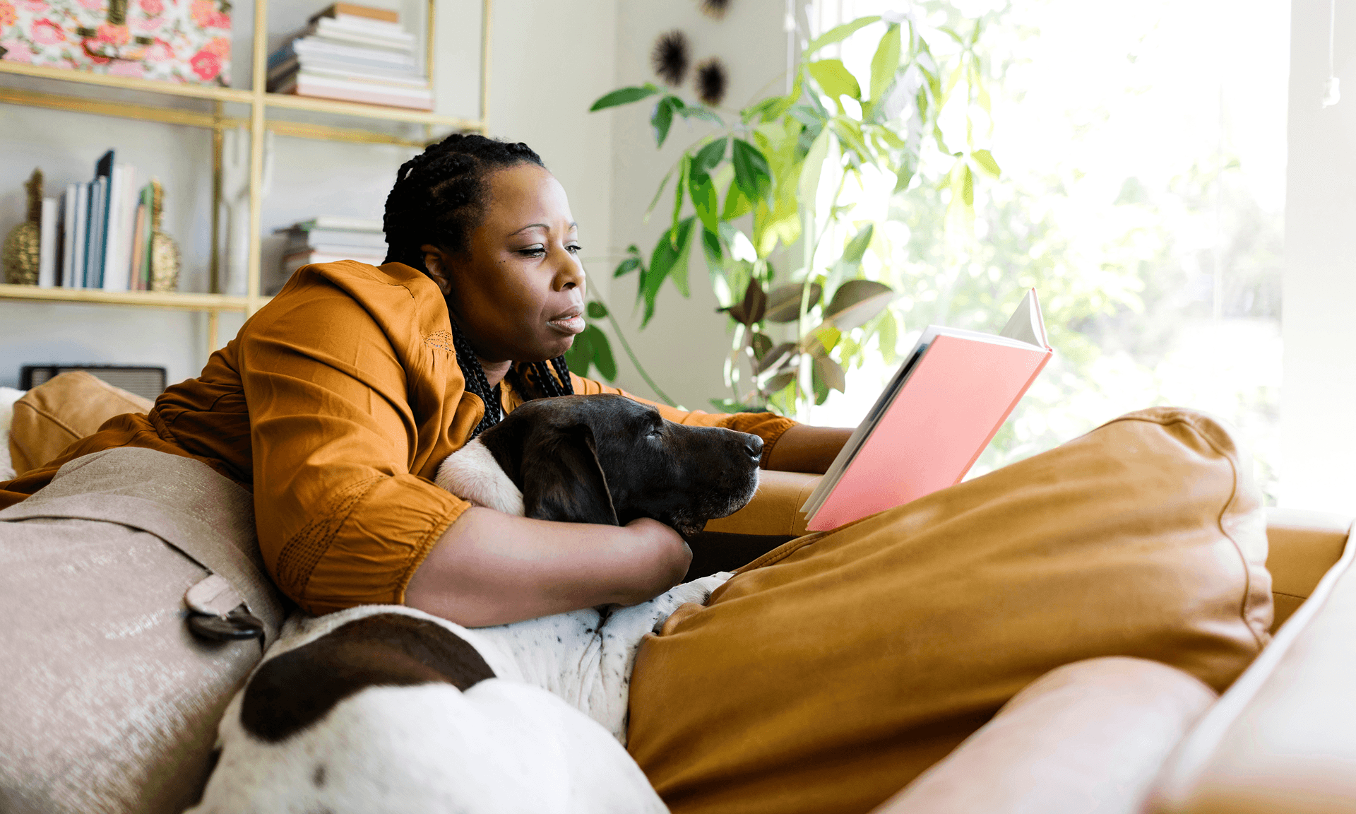 Woman reading with dog