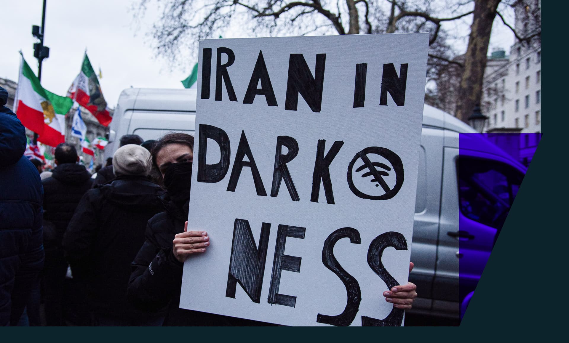 Iran protester holding a sign that reads "Iran in darkness"