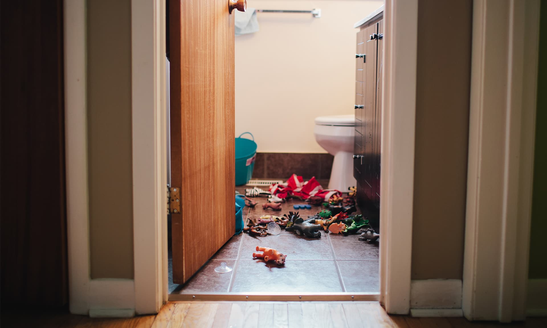 toys scattered on bathroom floor
