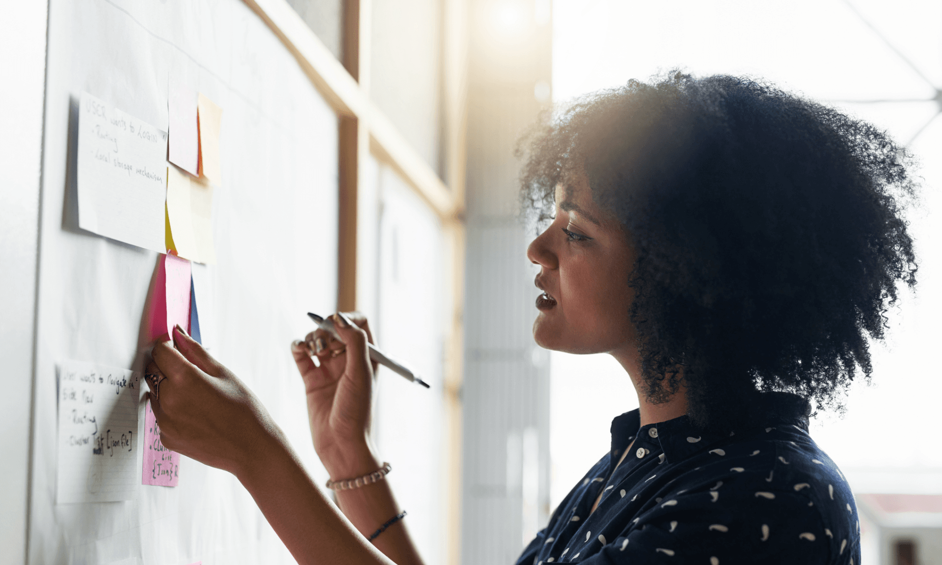 Woman writing on sticky notes